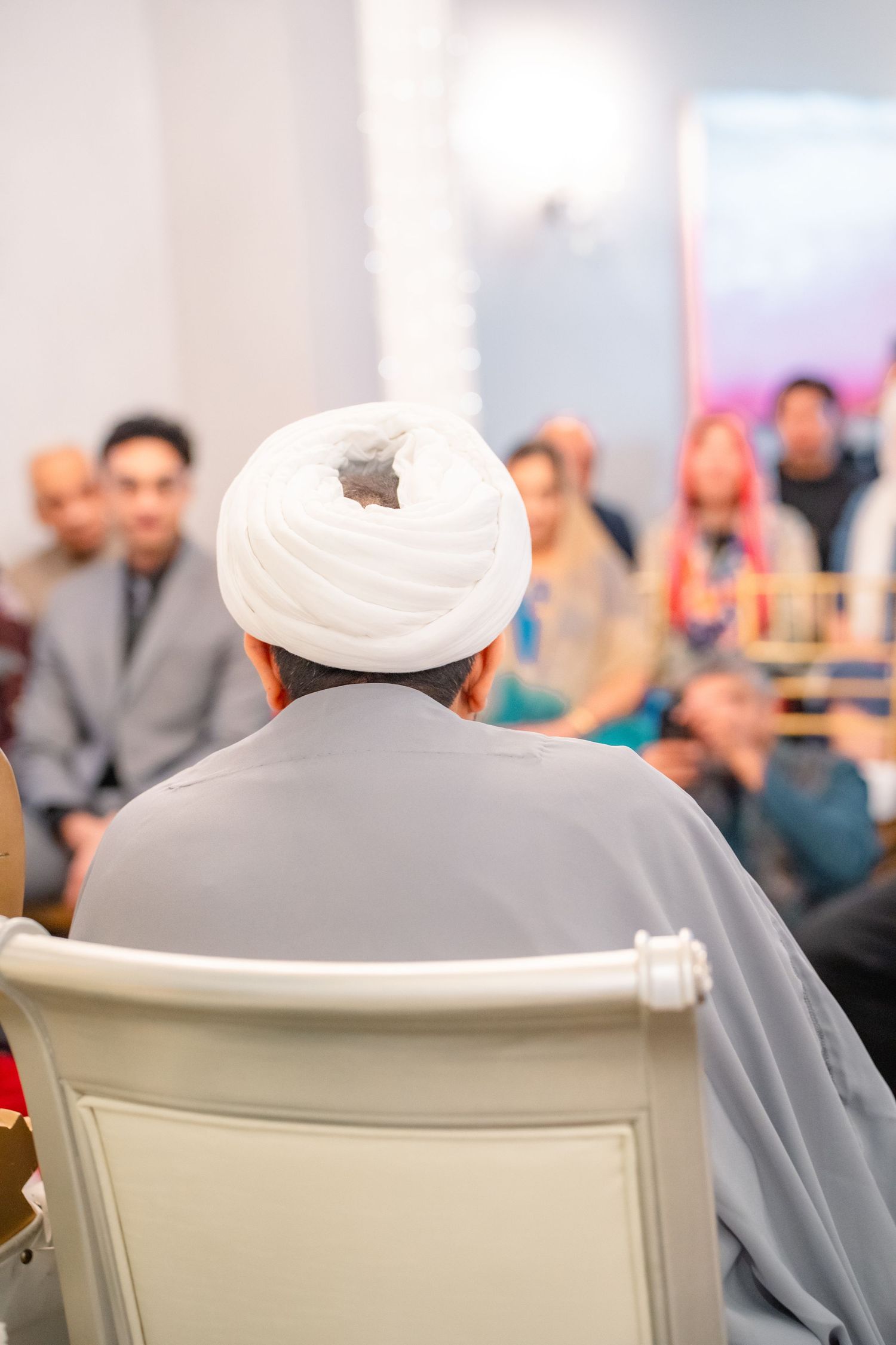 Priest giving wise words infront of couples's family at a traditional wedding