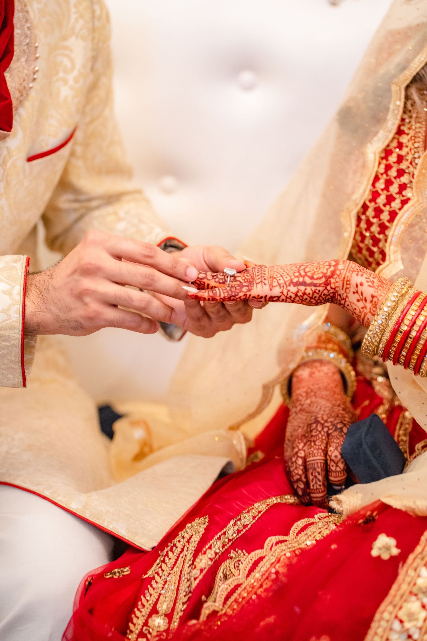 Couples exchanging their wedding ring at their traditional wedding clothing