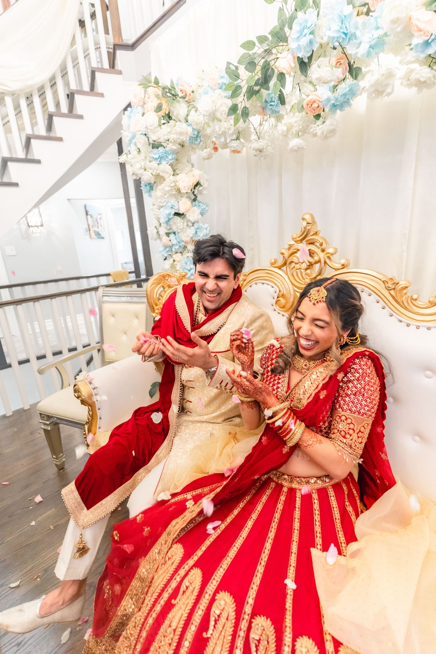 Couples getting flower petals thrown at in heir traditional wedding clothing