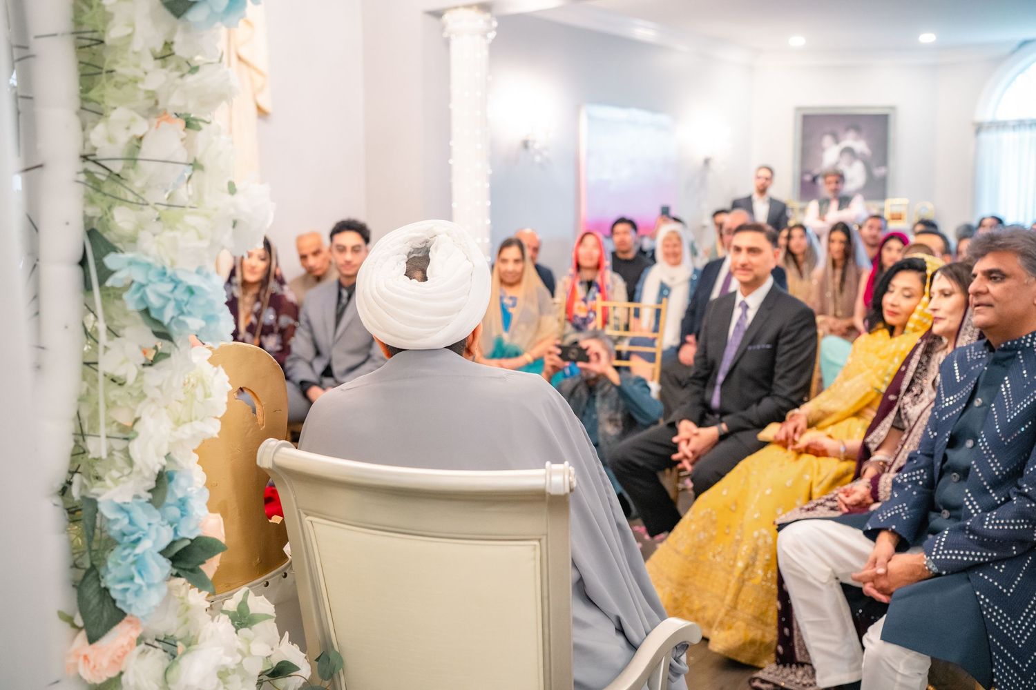 Priest giving wise words infront of couples's family at a traditional wedding