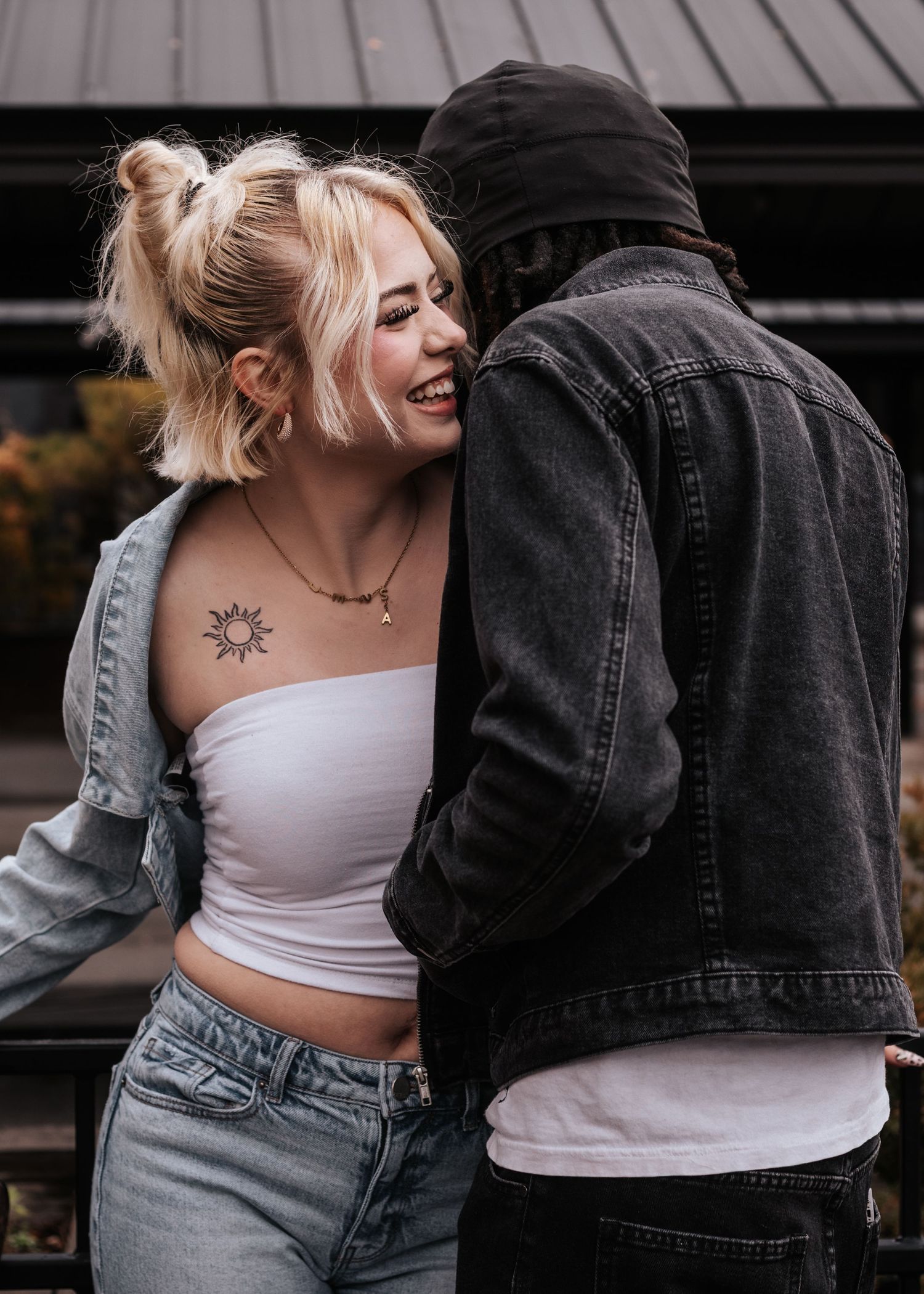 A couple in denim and casual wear sharing intimate moments in a series of black and white photographs.