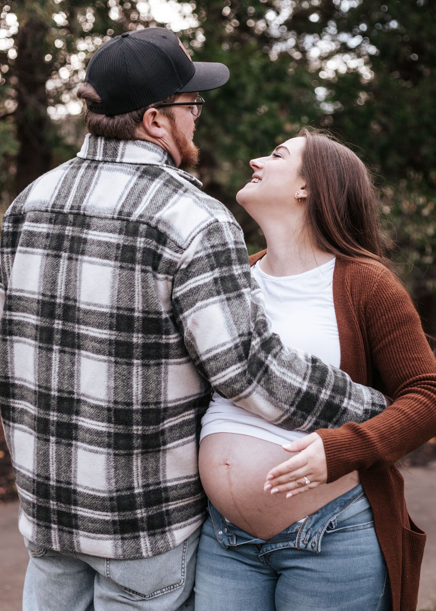 Couple in casual attire sharing intimate moments in a series of outdoor photos showing affection and pregnancy.