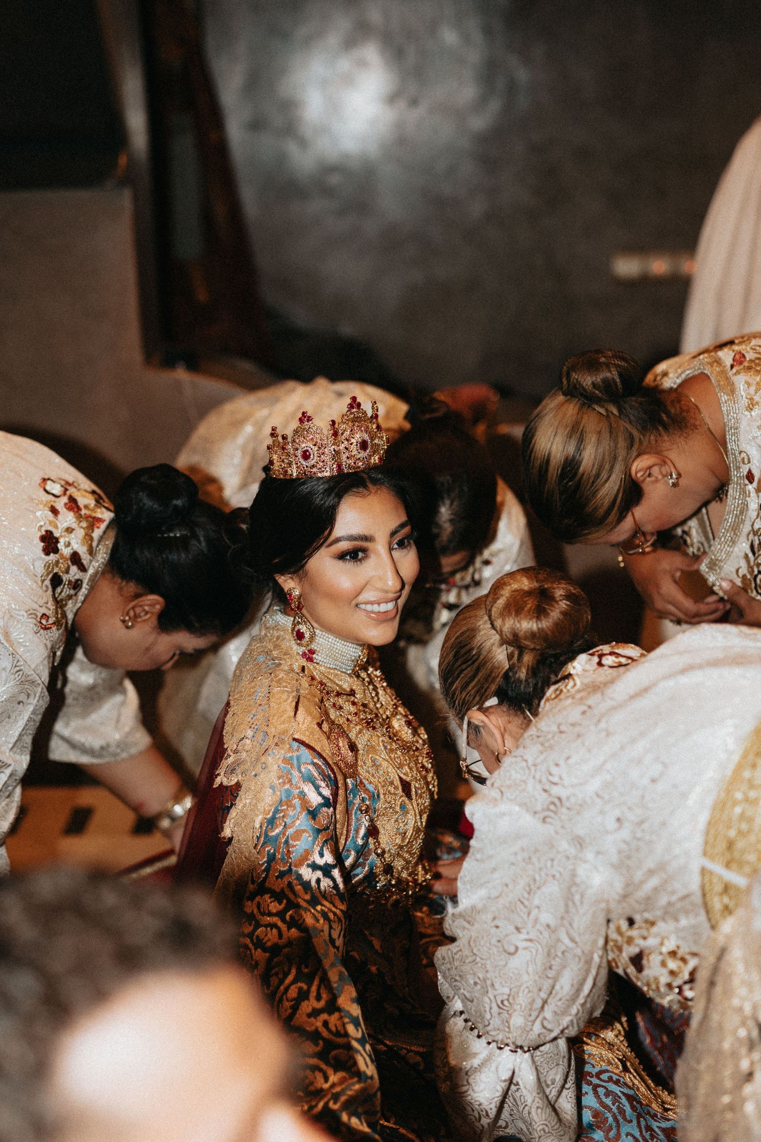 Bride smiling inside the decorated Amaria during her traditional Moroccan wedding