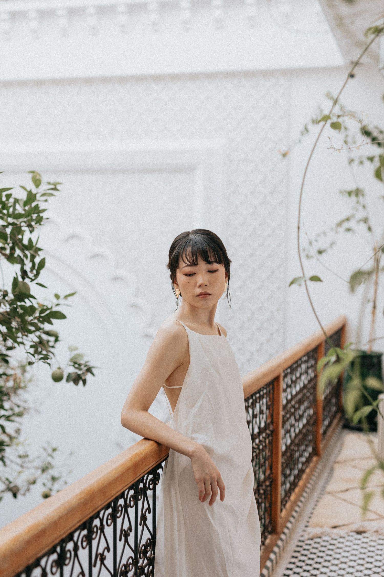 Bride framed by arched riad doorway in a timeless fine art style