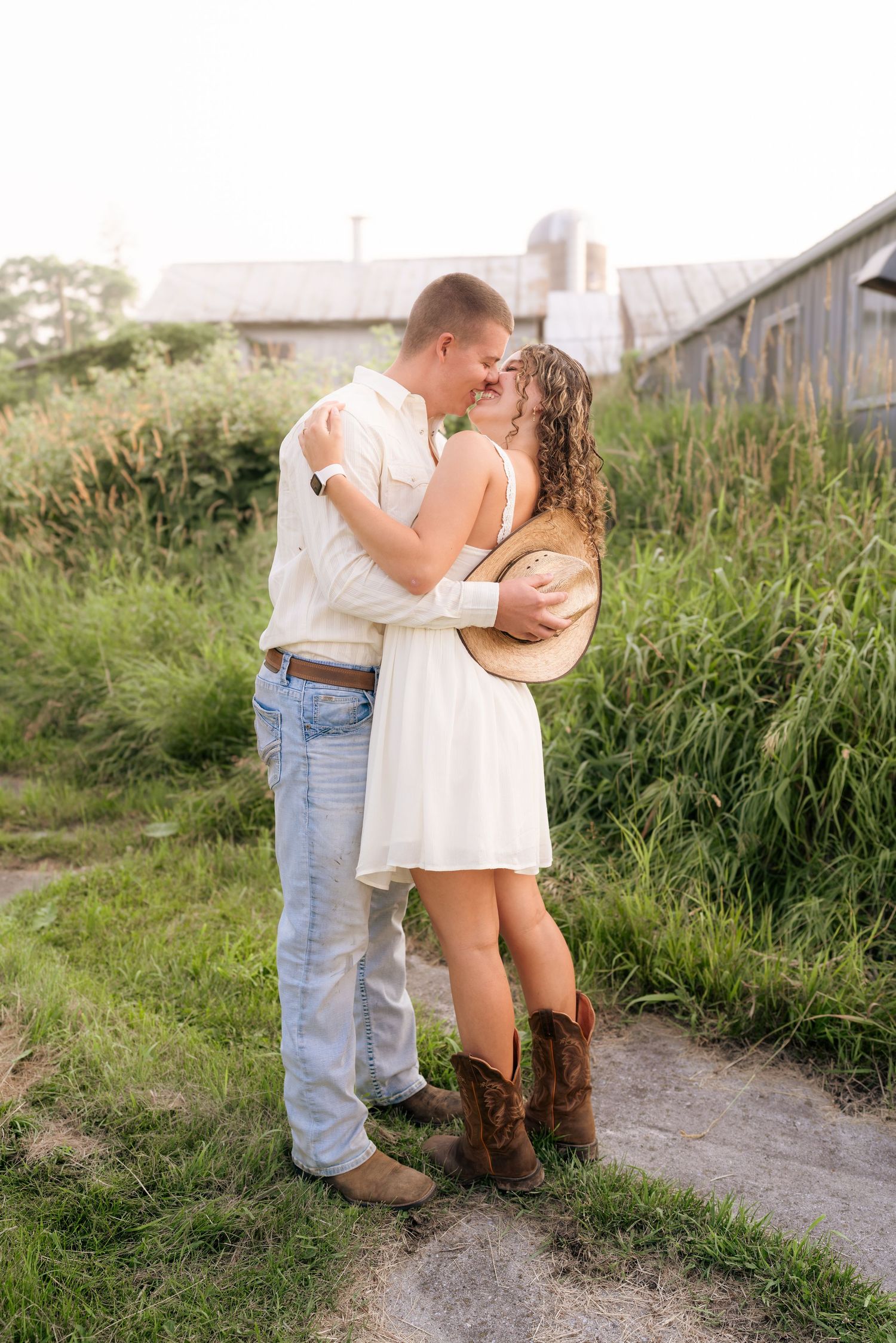 Romantic countryside photoshoot with rustic barn setting and natural lighting.