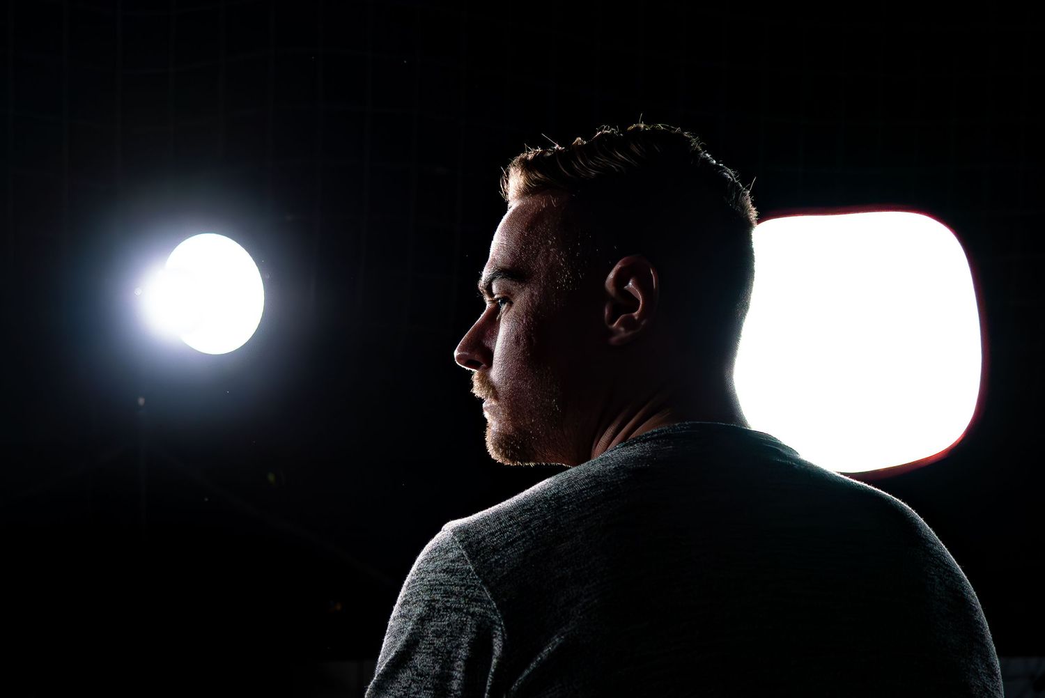 Dramatic silhouette portraits with bright backlighting in dark environment.