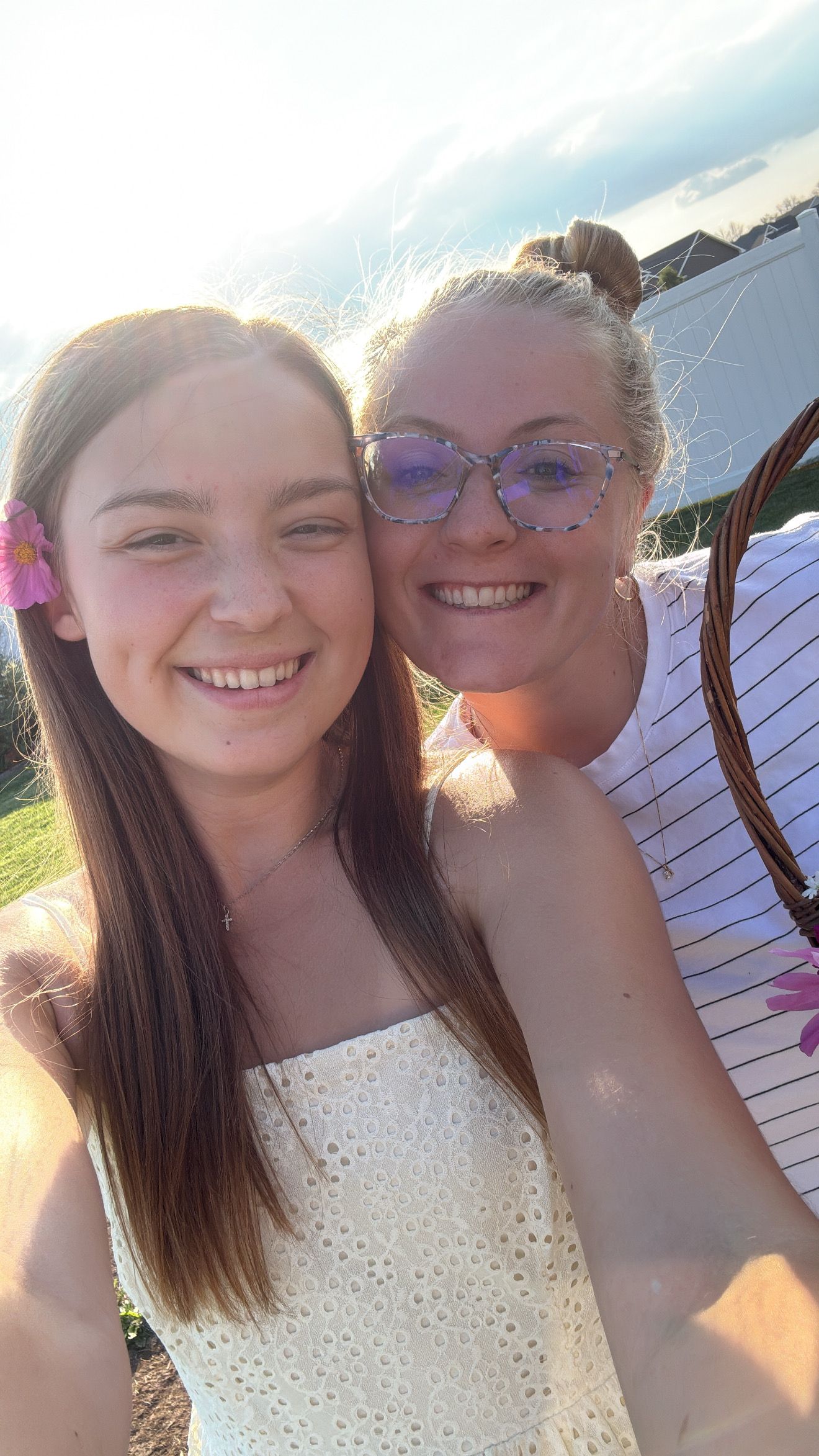Friends taking selfies together at sunset.