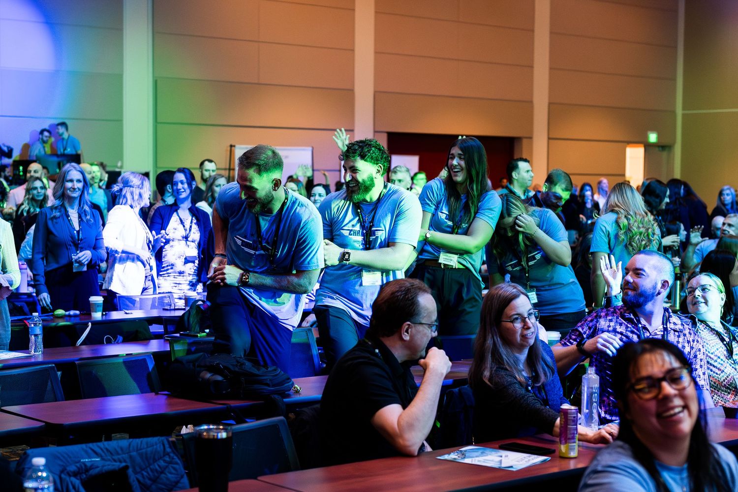 Engaged audience members watching intently during a conference presentation.