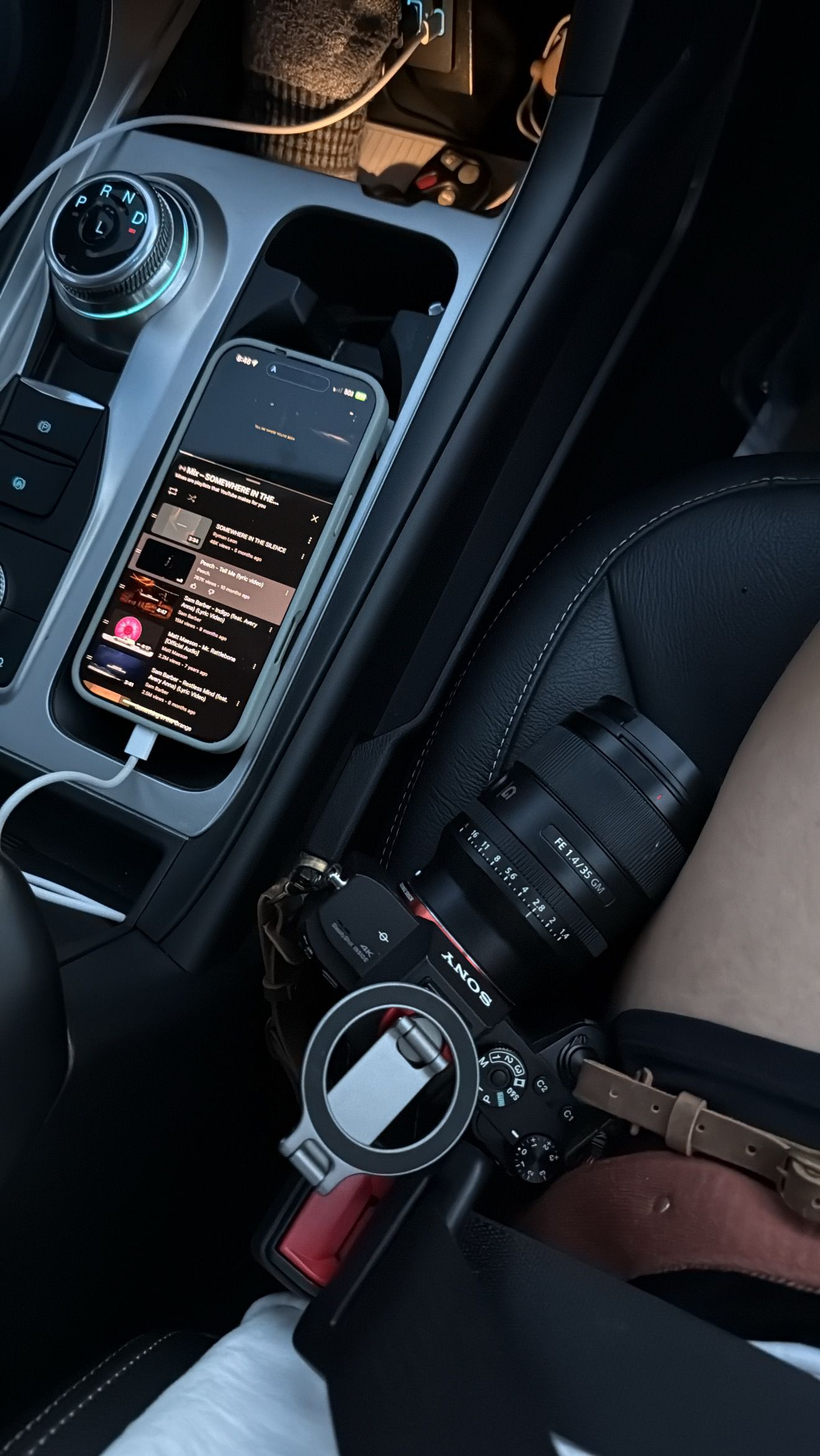 Dark interior of a car showing modern touchscreen display and controls.