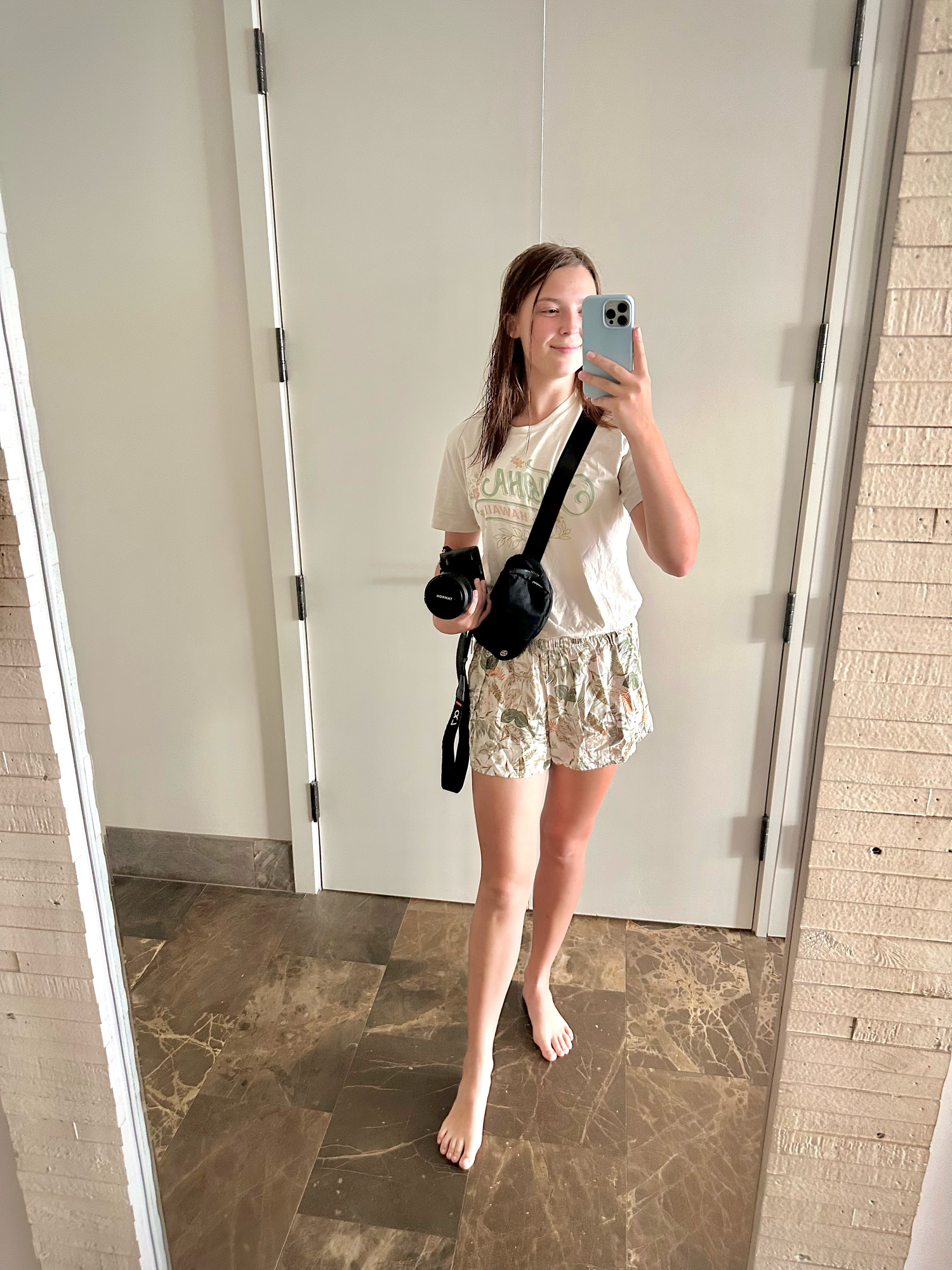 Mirror selfies showing an outfit in a modern interior with beige marble floors.