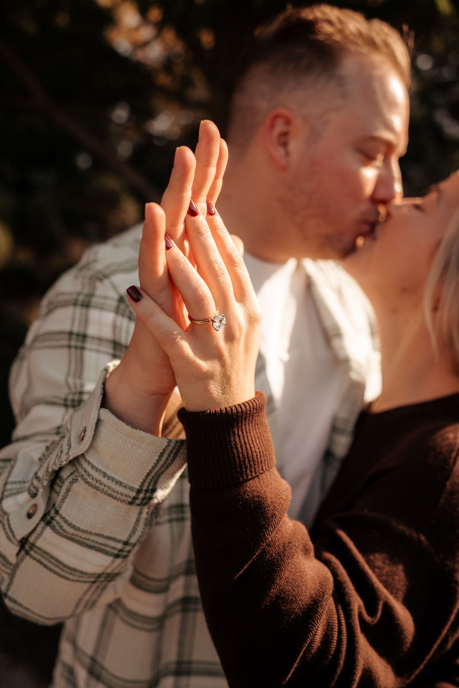 Close-up sequence showing a hand with an engagement ring against a dark background.