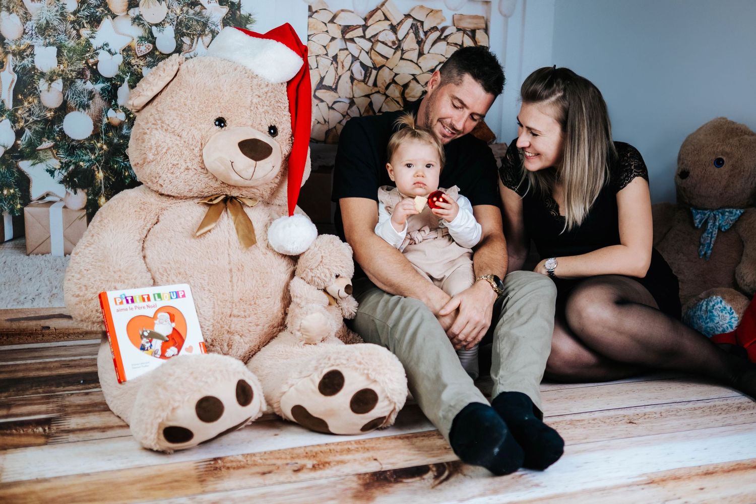 A collection of holiday-themed family photos featuring a large teddy bear and festive Christmas decorations.