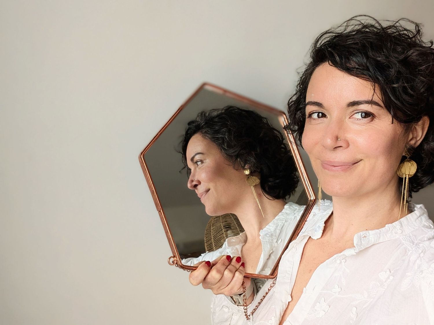 A person in a white top and dark curly hair is shown in a series of profile shots against a neutral background.