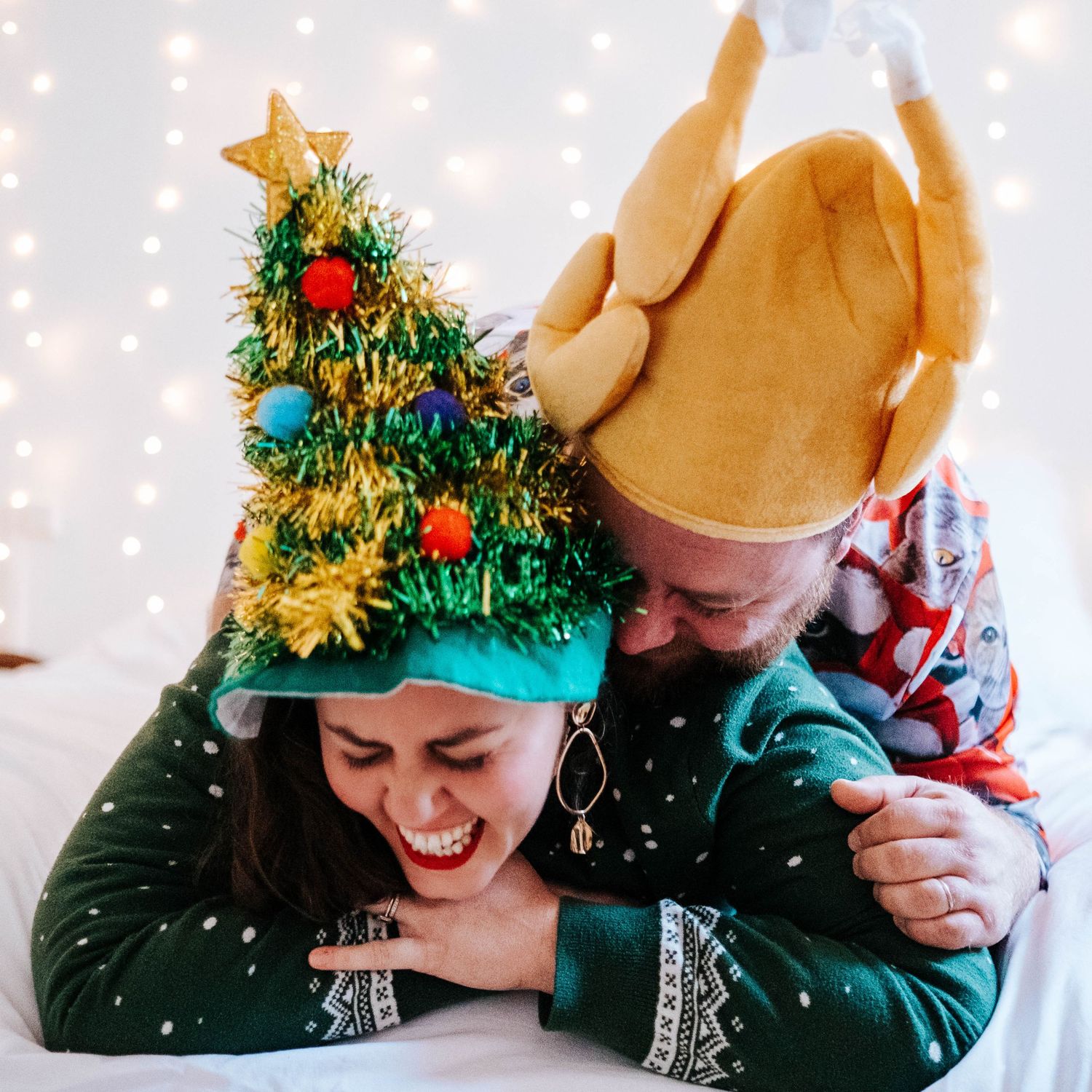 Festive holiday photoshoot with twinkling lights and Christmas decorations creating magical atmosphere.