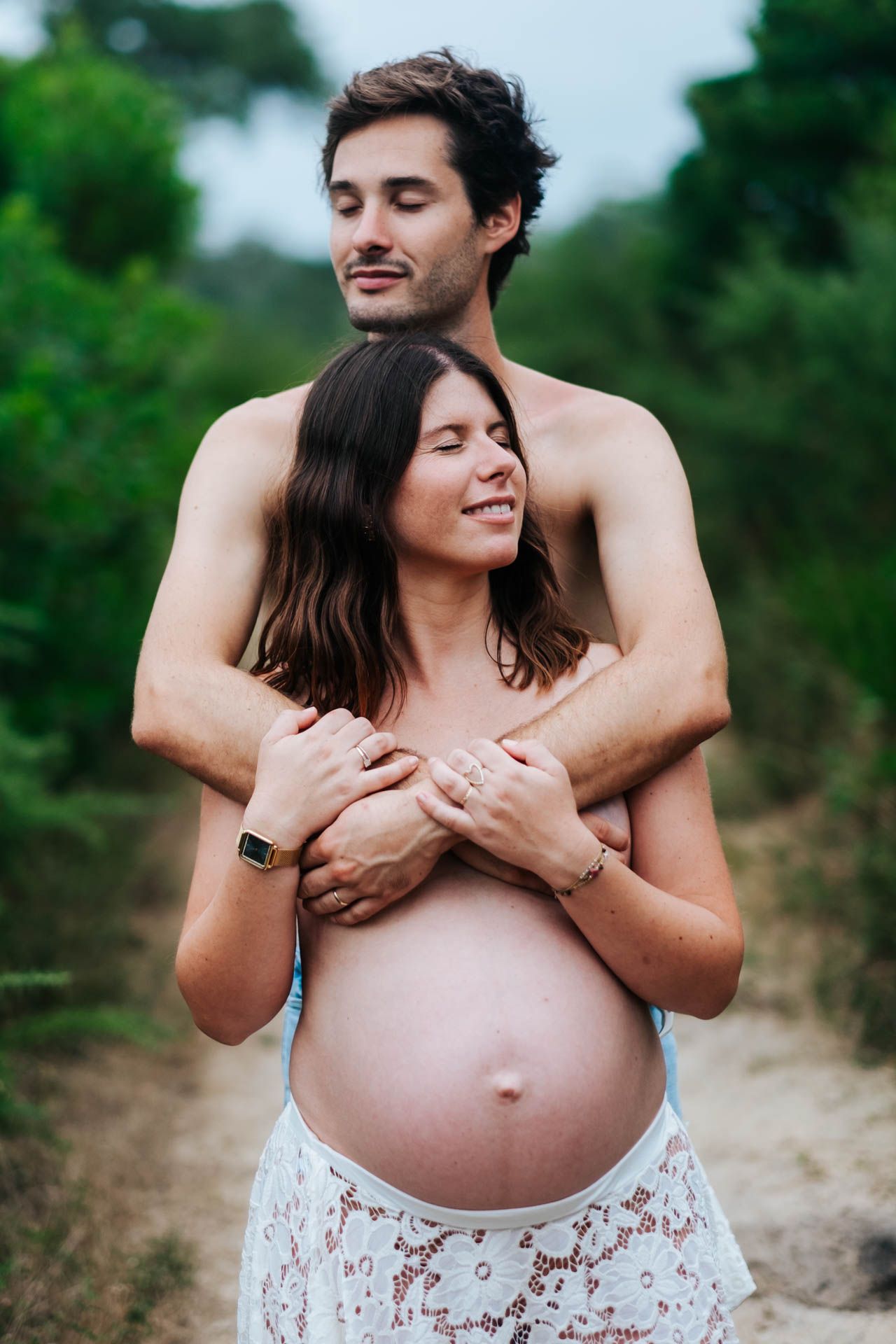 A maternity photo sequence showing a loving embrace and bare pregnant belly against a green outdoor background.