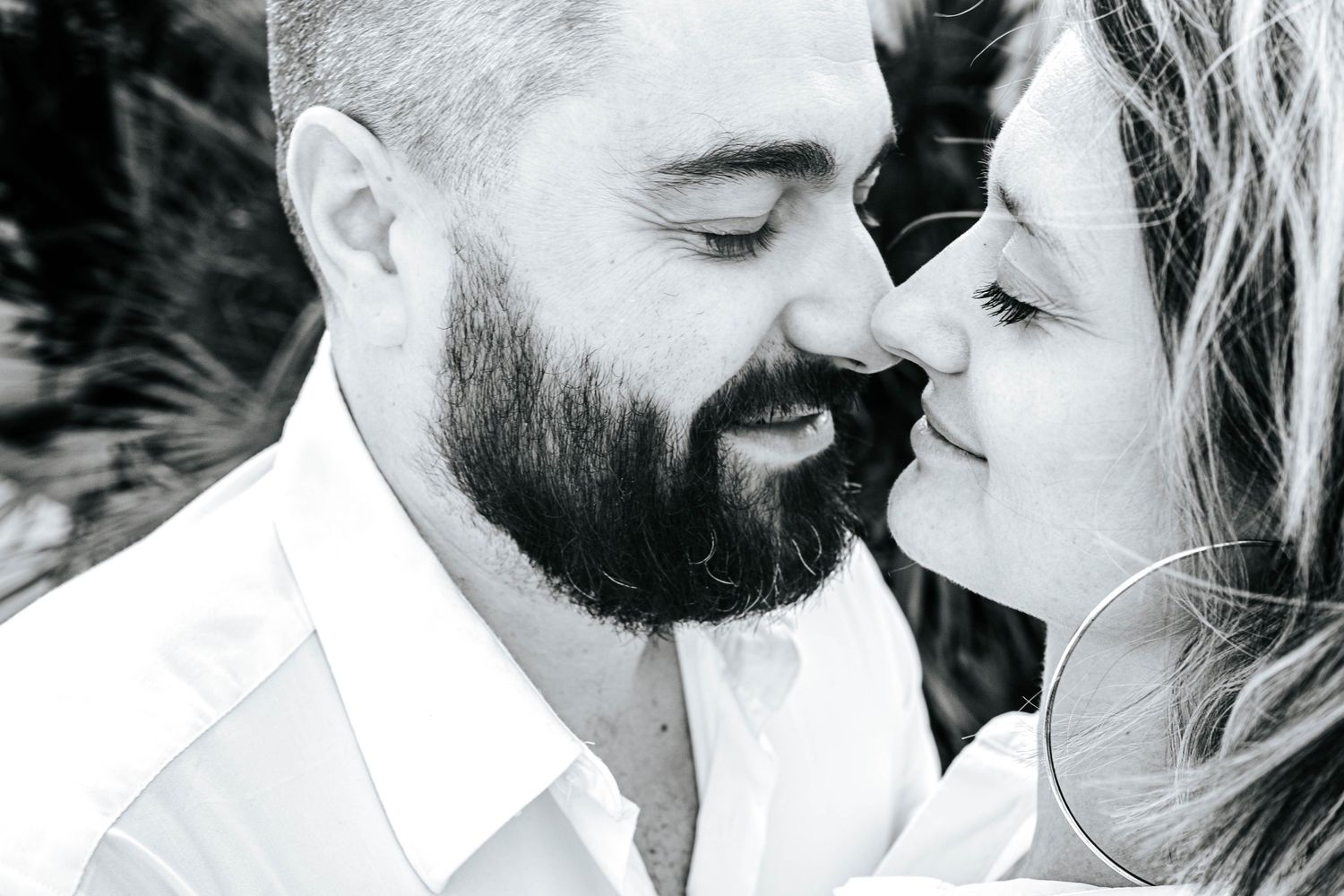 A romantic black and white close-up photo of a couple sharing an intimate moment together.