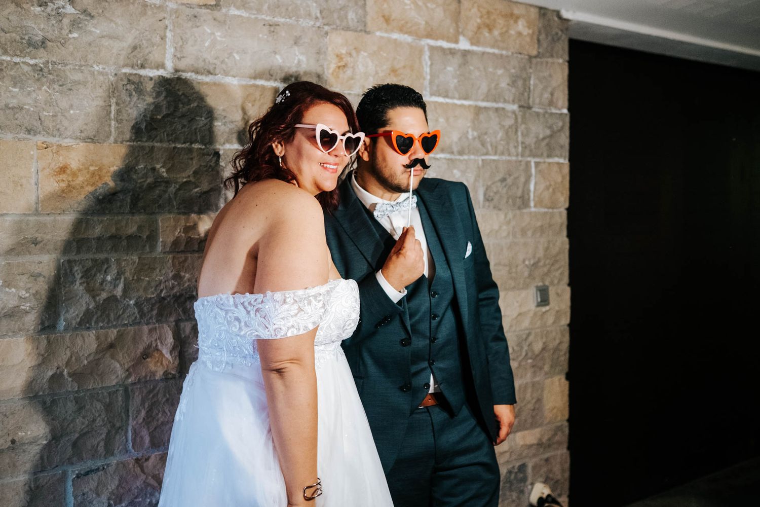 Wedding couple photos against a rustic stone wall background.