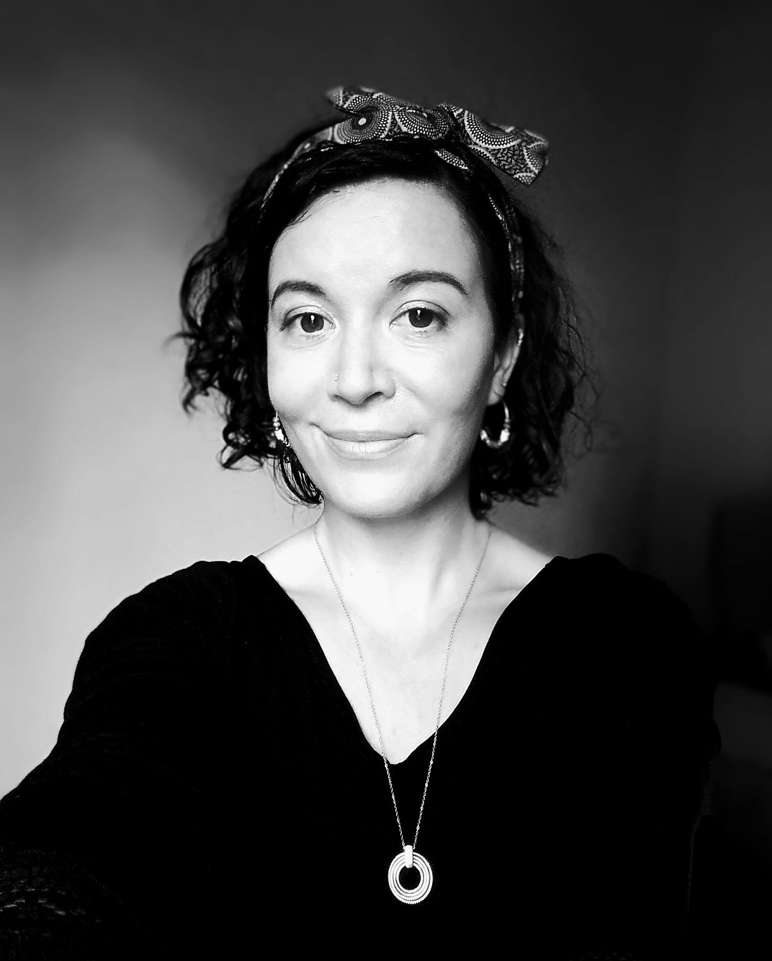 Black and white portrait series showing dramatic lighting and shadows against dark backgrounds.