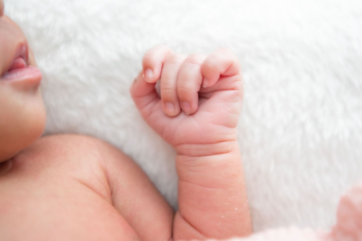 Series of close-up photographs showing newborn baby's tiny hands and feet.