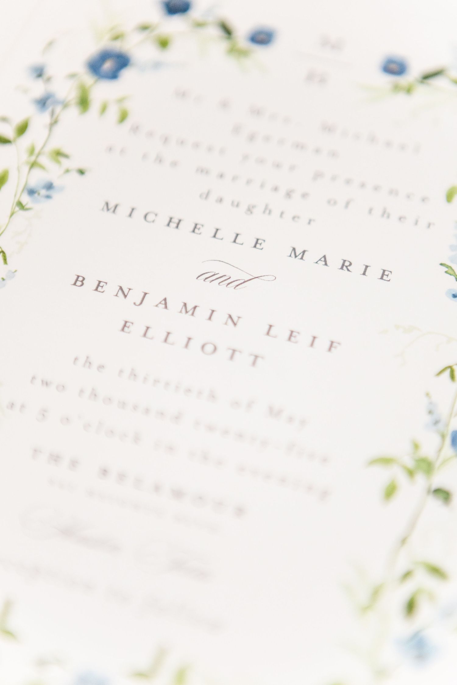 Wedding invitation details with delicate blue floral watercolor design.