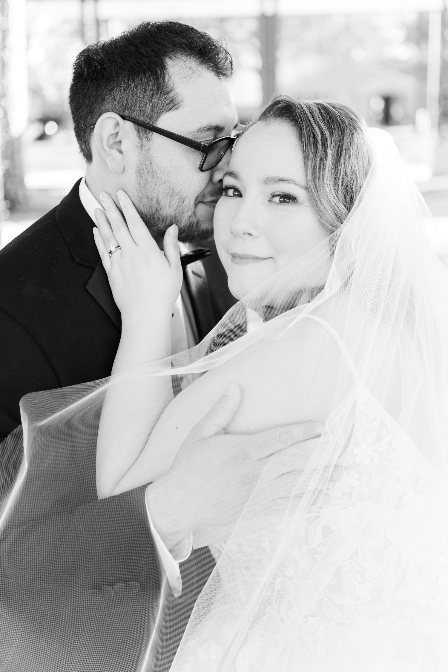 A romantic black and white sequence of wedding photos showing close-up moments between newlyweds.