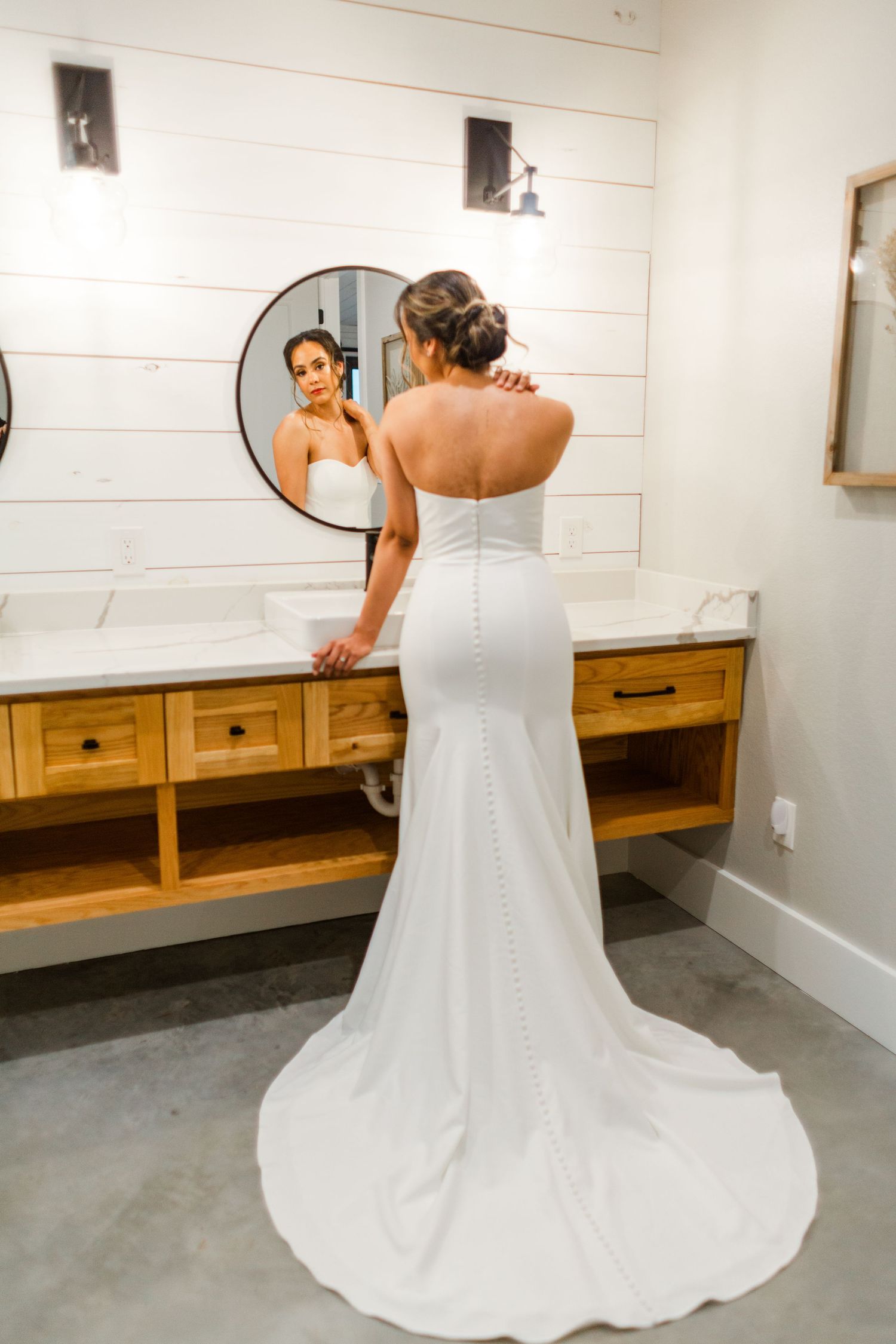 A series of photos showing a flowing white wedding dress from different angles in a dressing room.