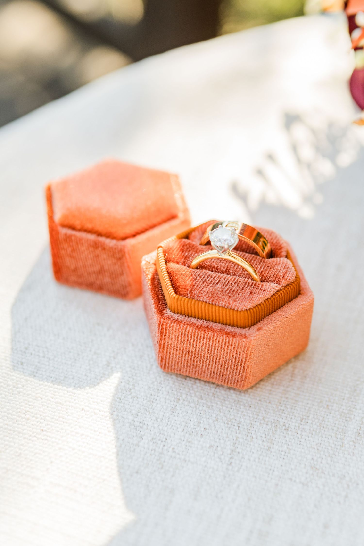 Close-up sequence showing the folding process of a coral-colored fabric ribbon or bow against a white surface.