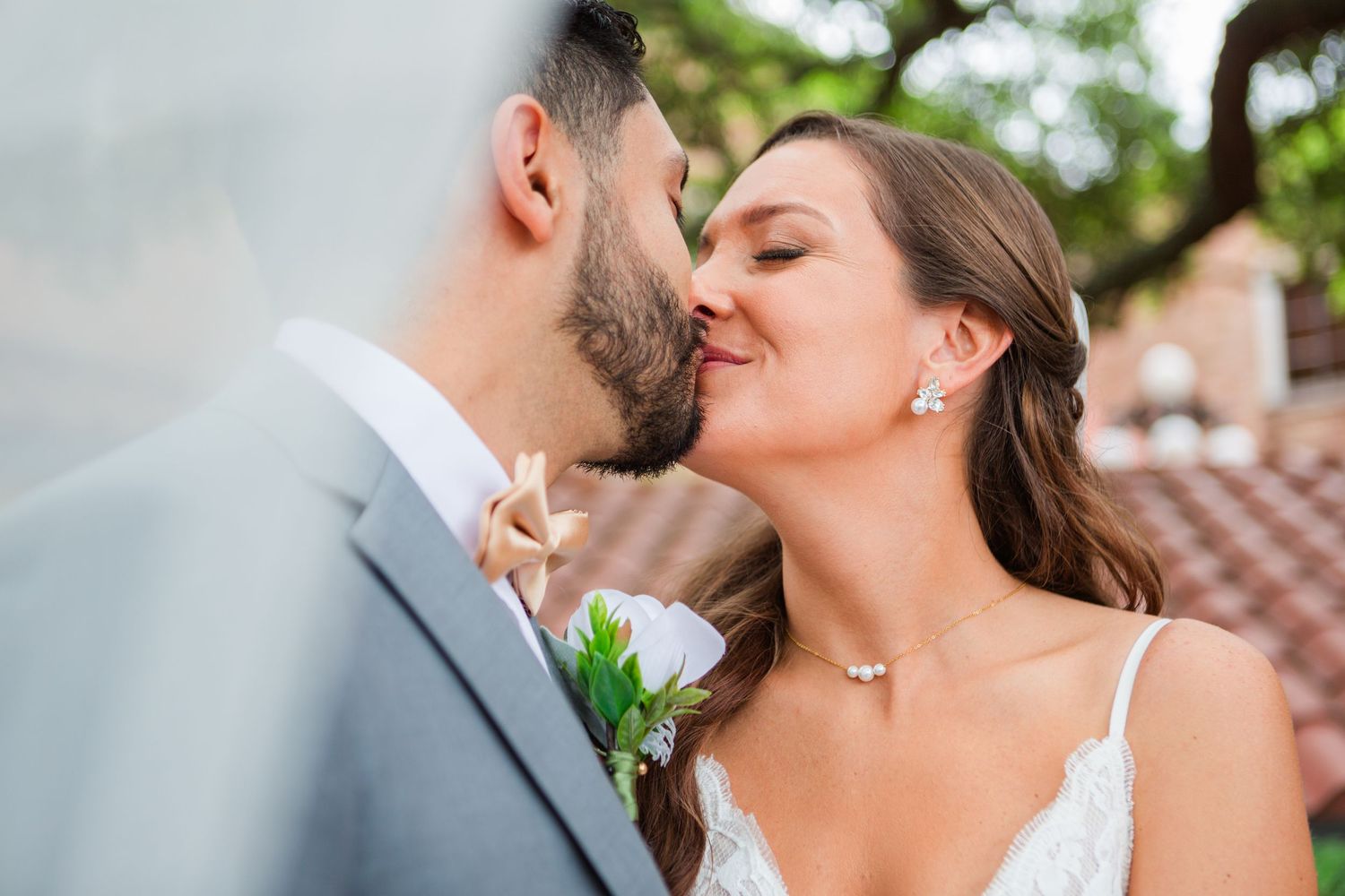 Happy wedding couple sharing intimate moment outdoors.