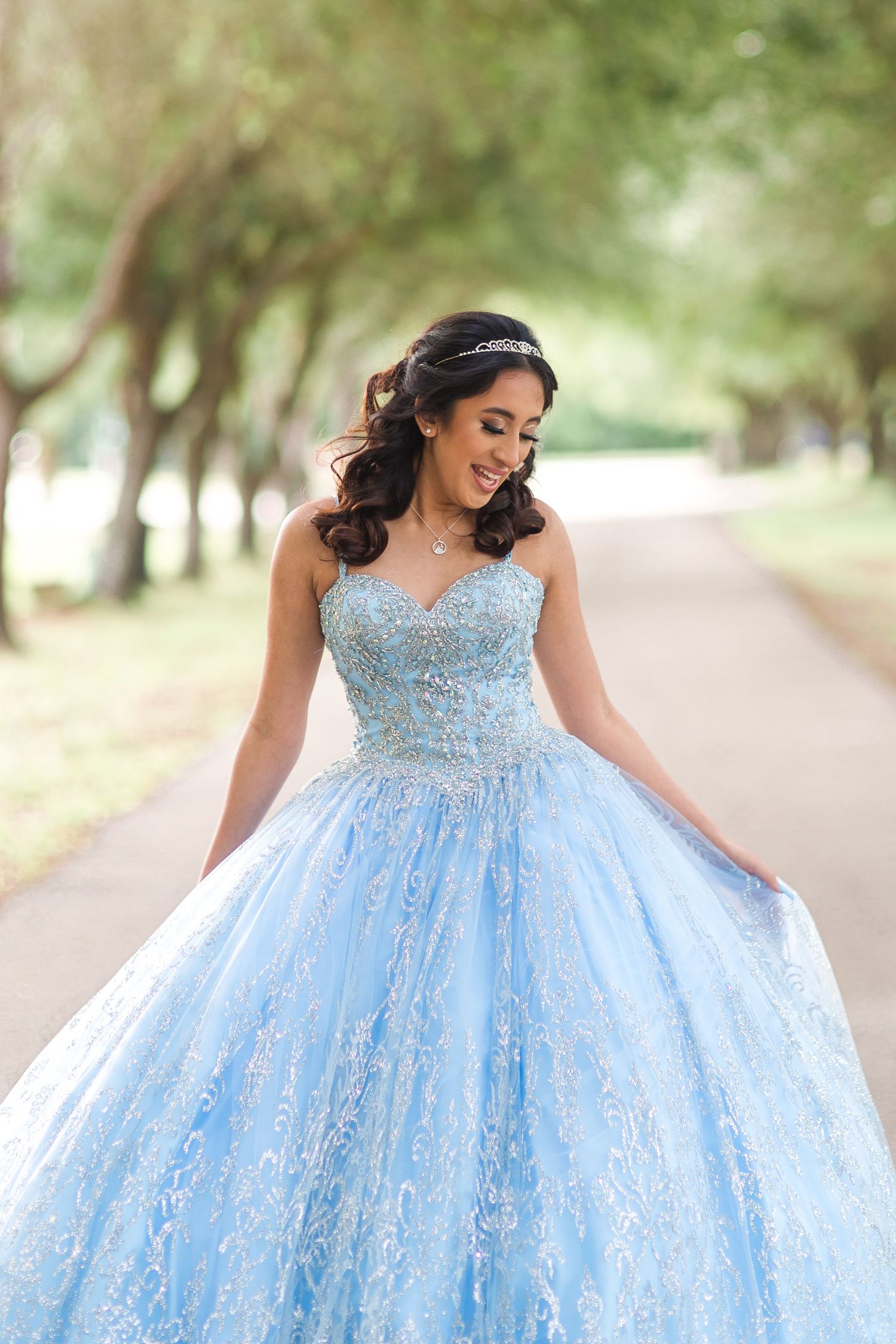 Stunning light blue quinceañera dress with sparkly details captured in an outdoor photo session.