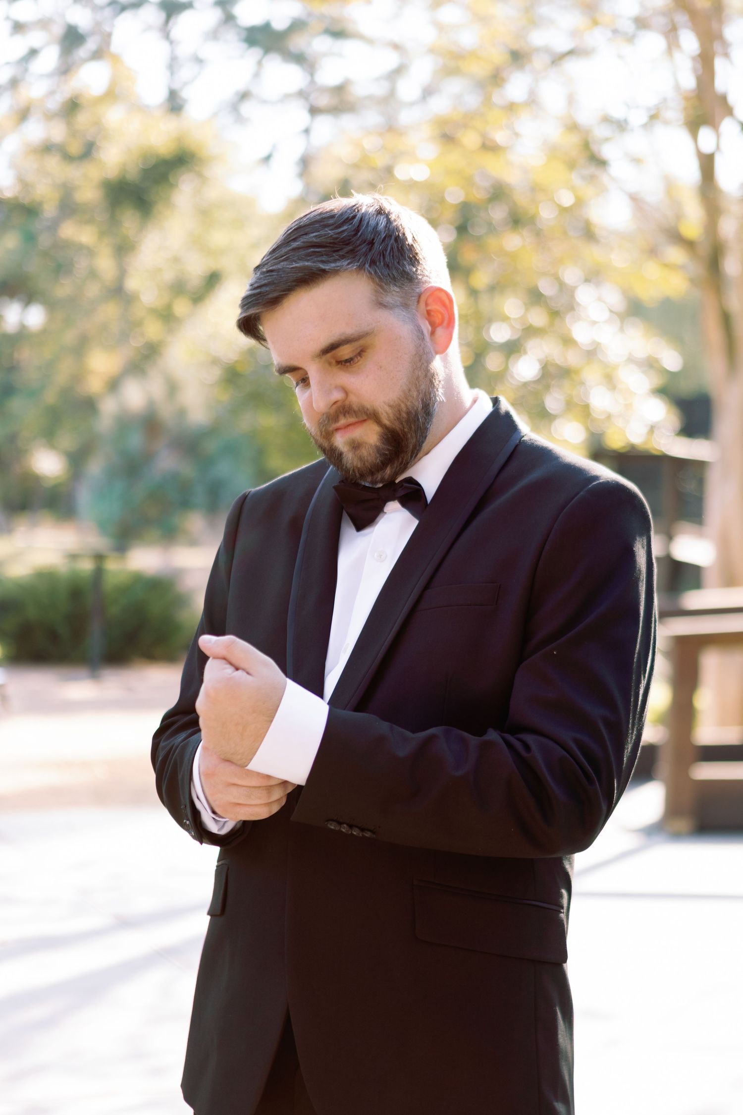 A person in a black suit jacket wipes their nose with a white tissue in a series of sequential photos.