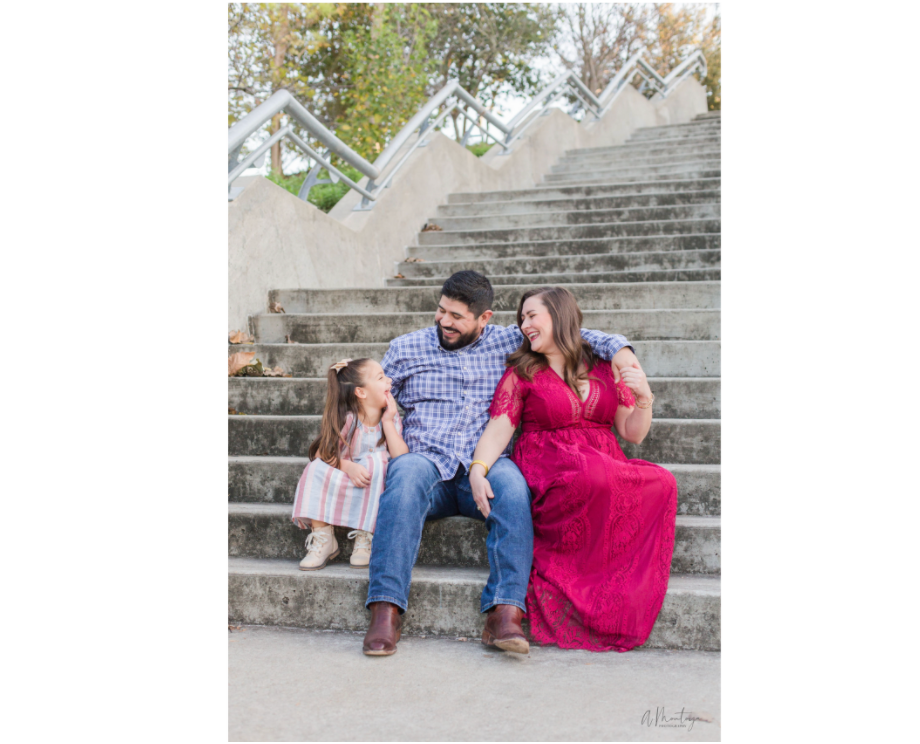 Couple sits casually on stone steps during outdoor photo shoot.
