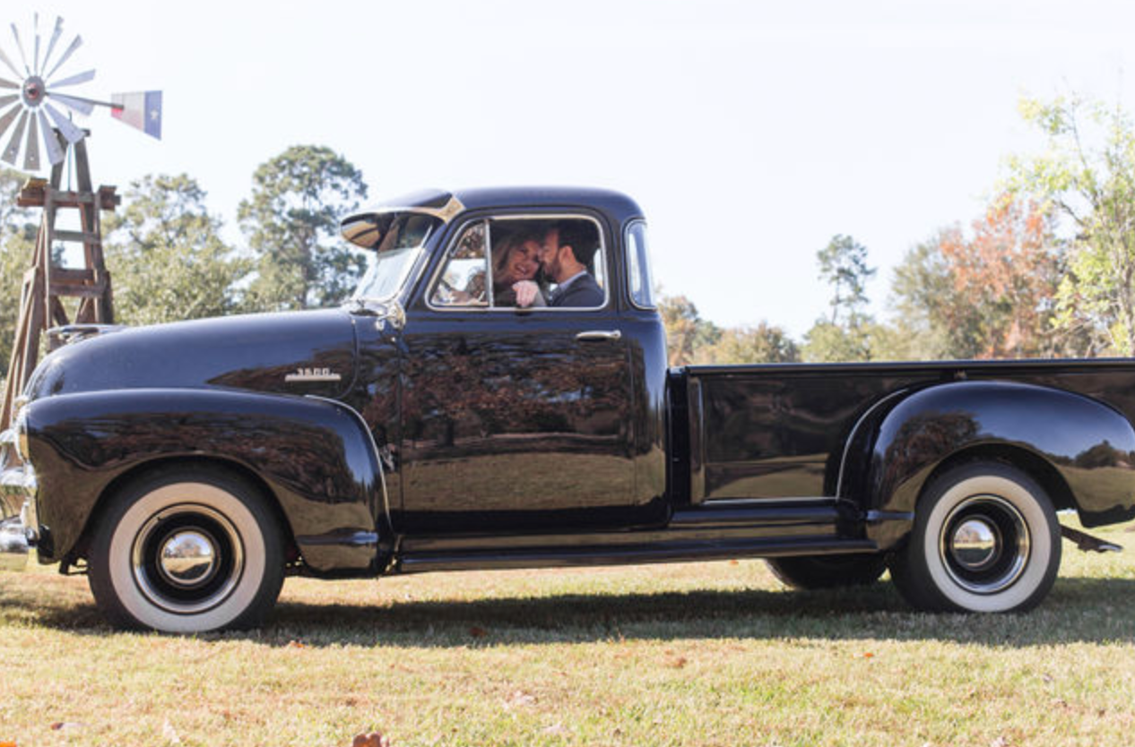 Classic black vintage car photographed from different angles on grass.