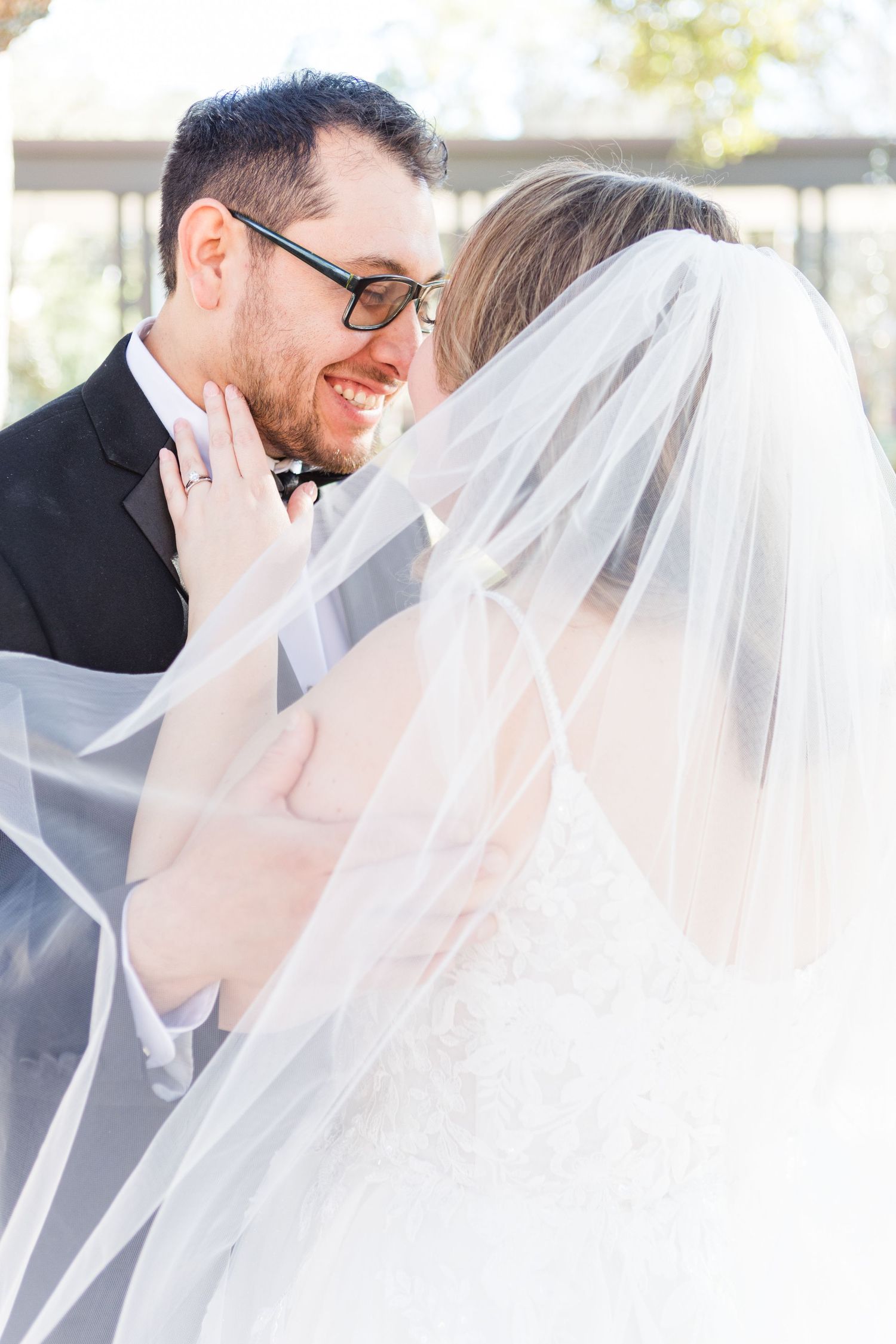 Artistic wedding photo series capturing intimate moments between a couple with a flowing veil.