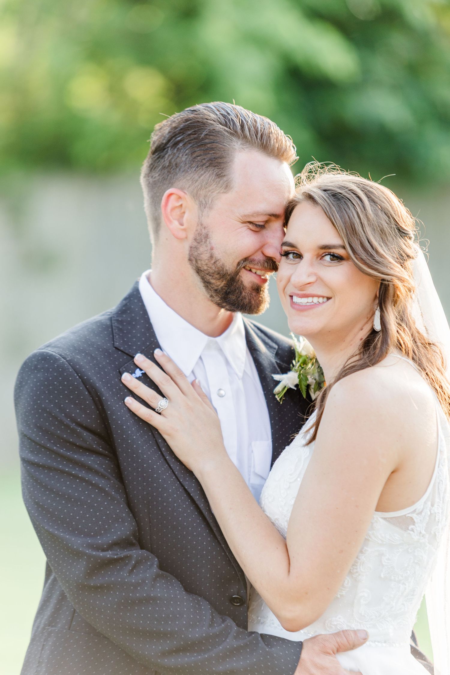 Joyful wedding couple sharing intimate moments in garden setting.