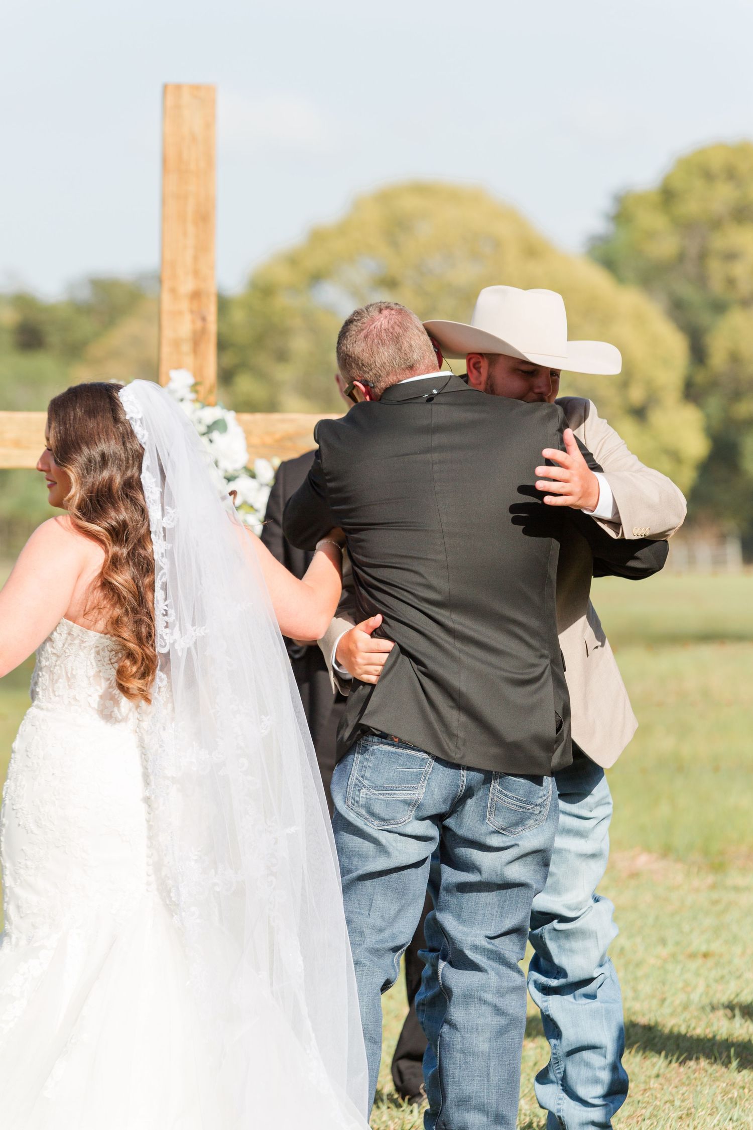 Candid sequence of wedding couple embracing outdoors in rustic country setting.