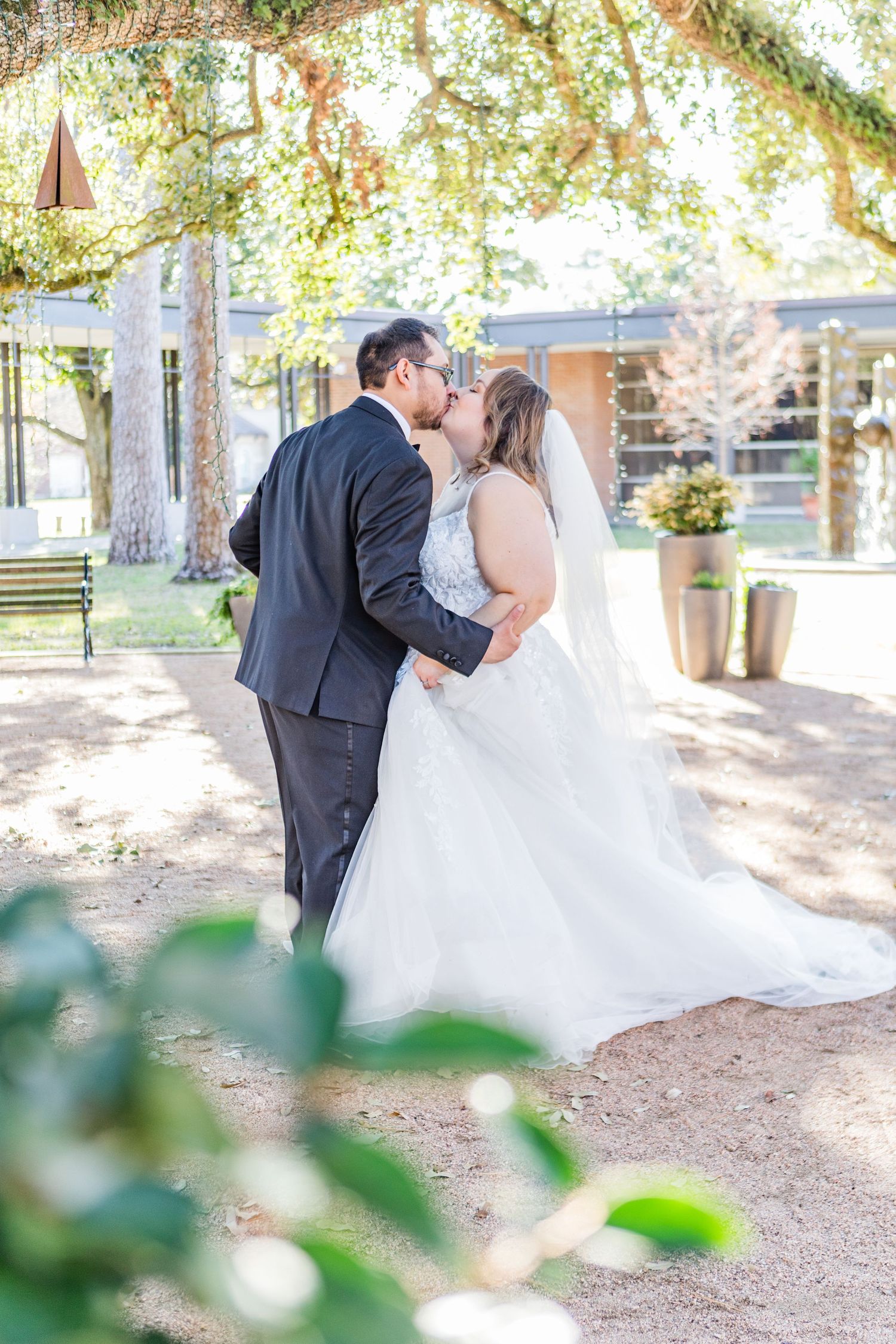 Wedding photography sequence showing a couple dancing and embracing in a sunlit garden.
