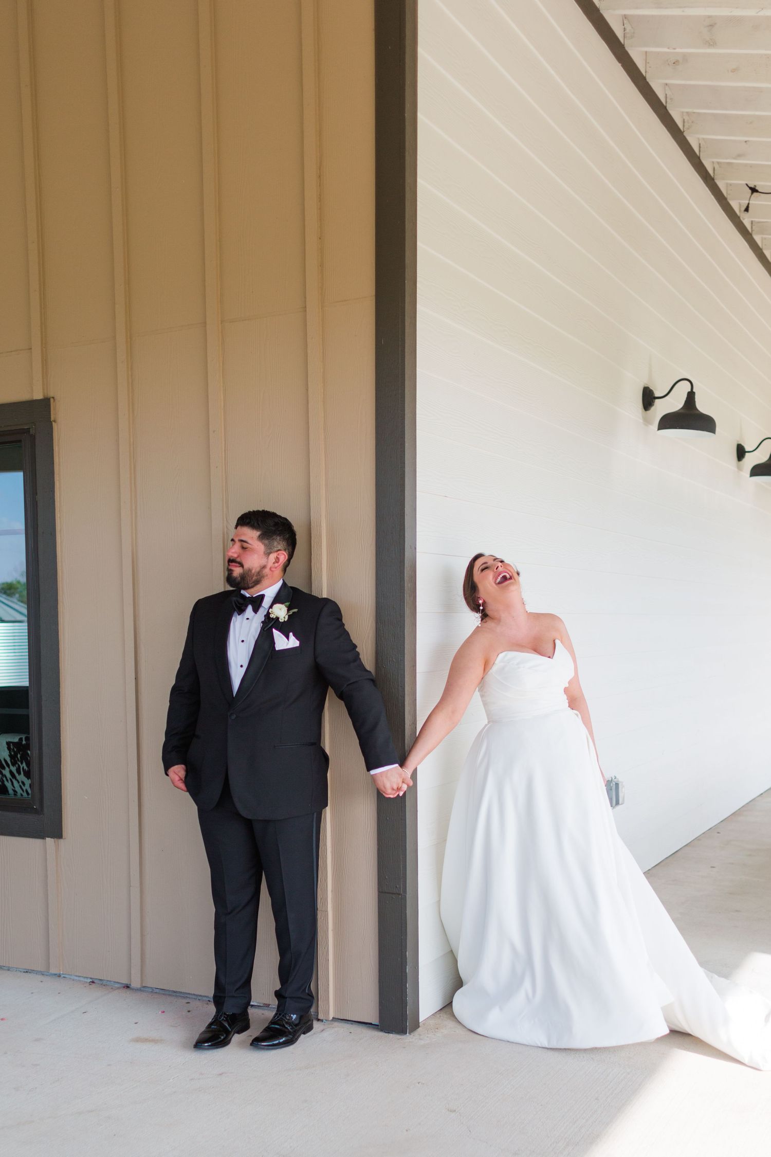 Candid moment of wedding couple laughing during their first look photography session.