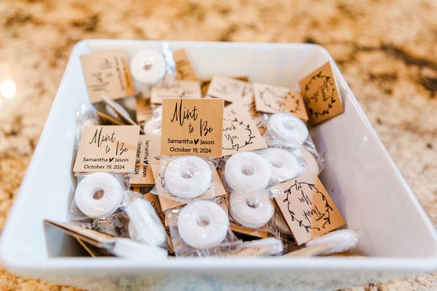 Wedding favors arranged on a white serving platter.
