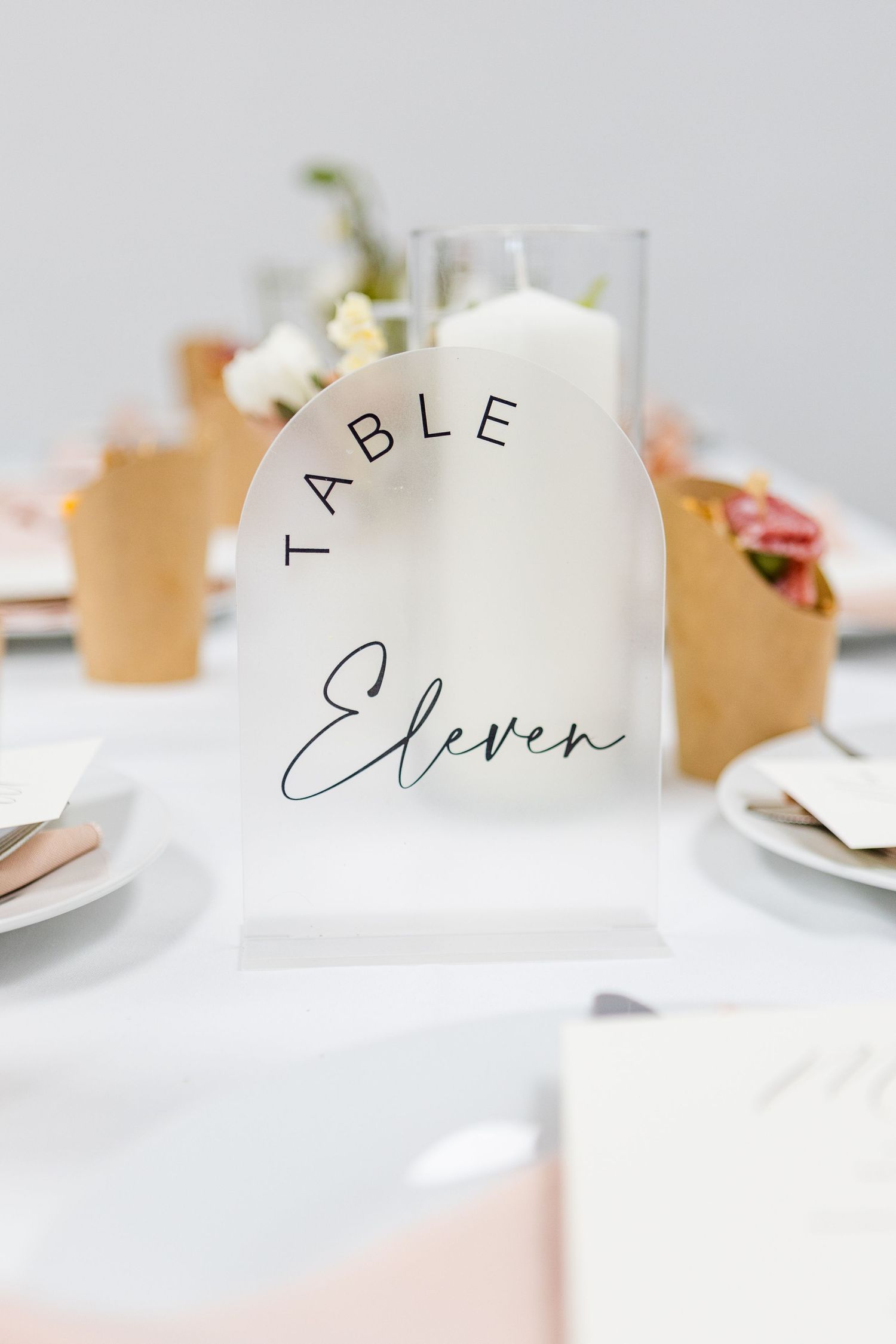Elegant wedding table setting with minimalist place cards in modern calligraphy.