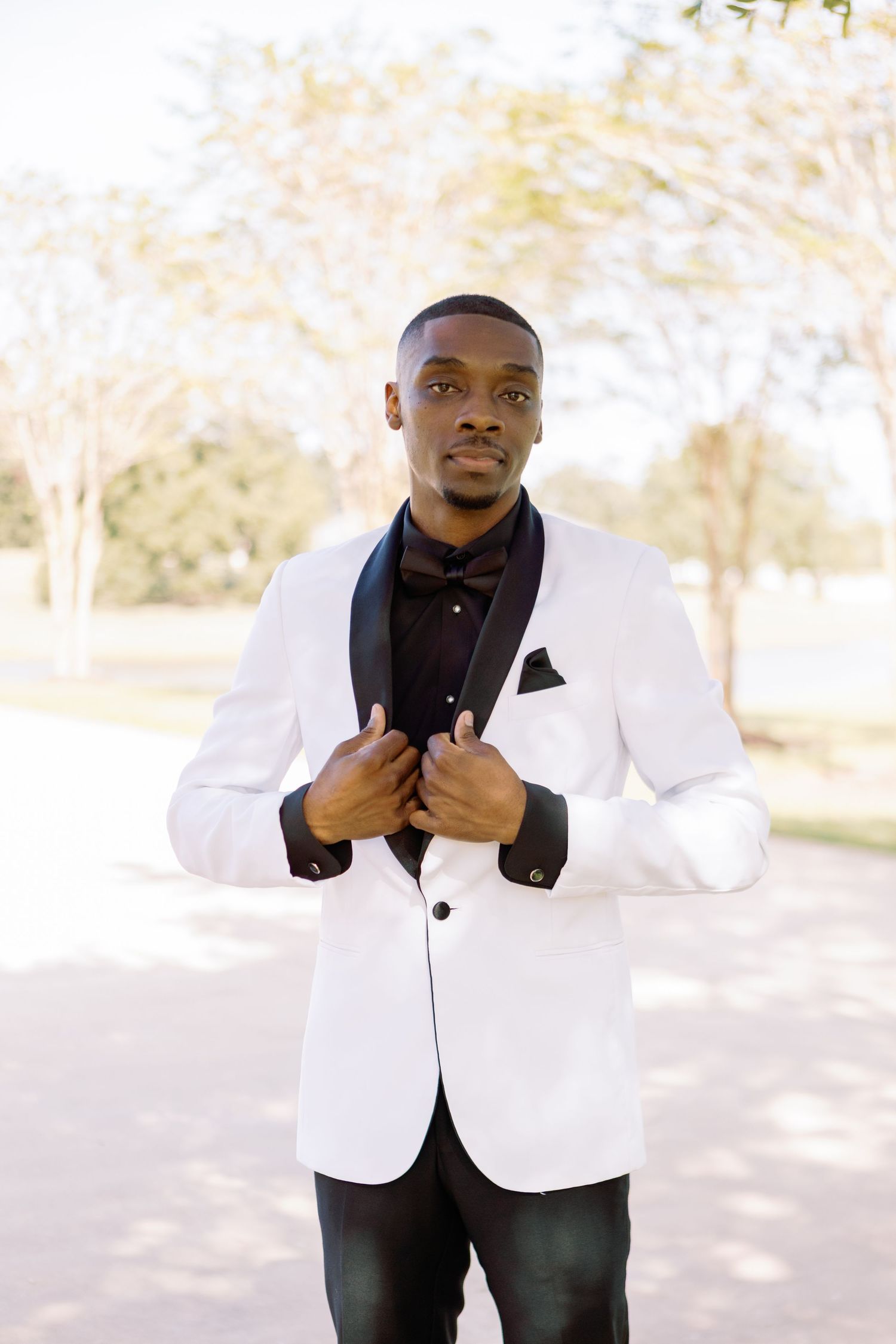 Person in white dinner jacket and black shirt posing outdoors in multiple candid shots.