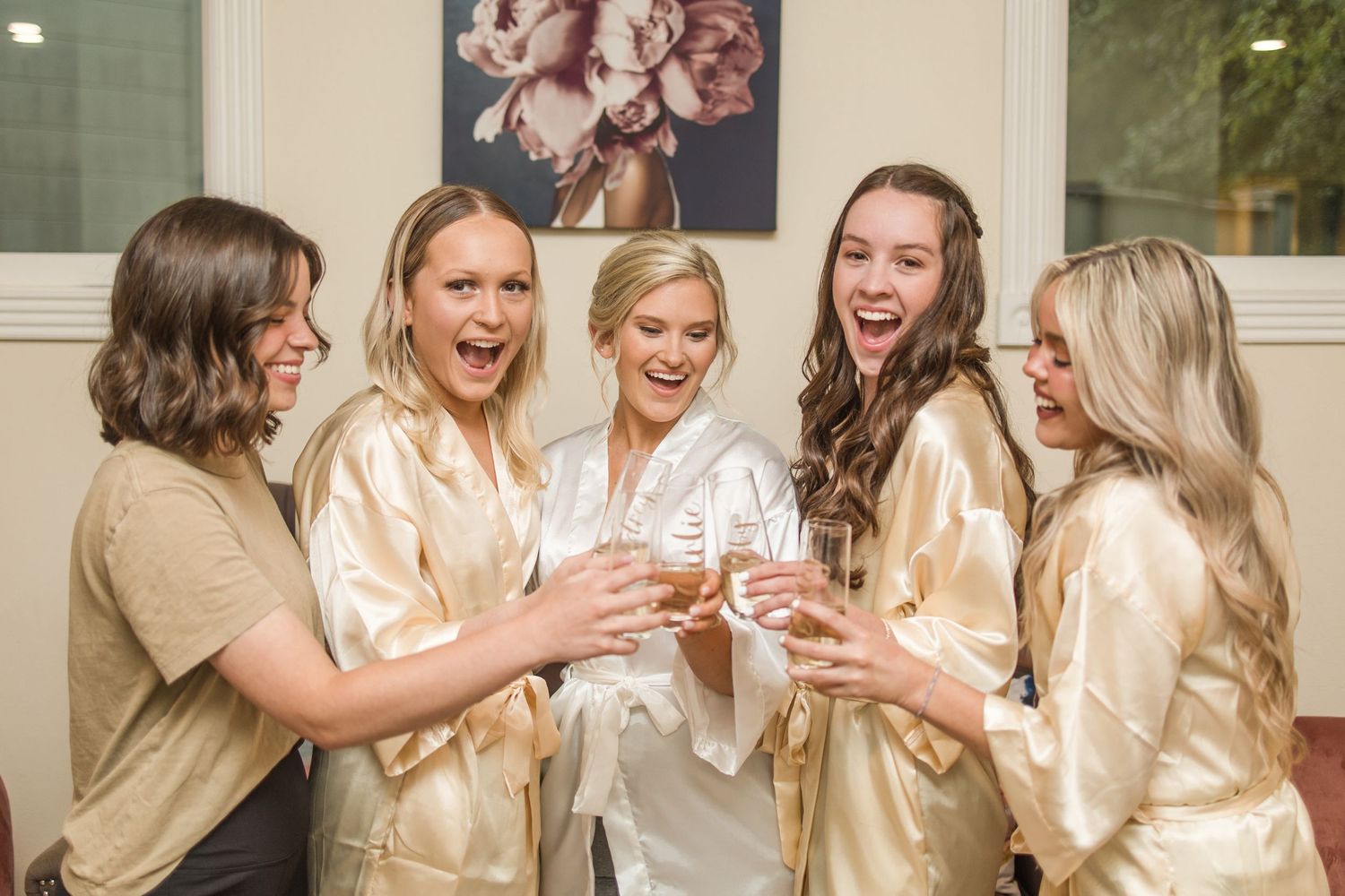 Candid moments of bridesmaids celebrating in matching champagne-colored robes.