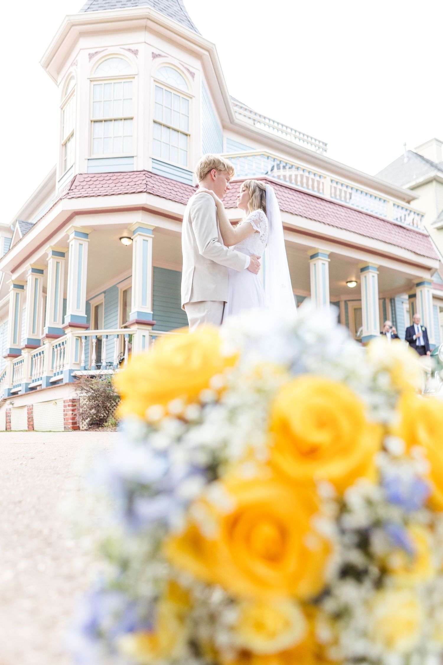 Victorian-style houses provide an elegant backdrop for a wedding scene with yellow floral accents.