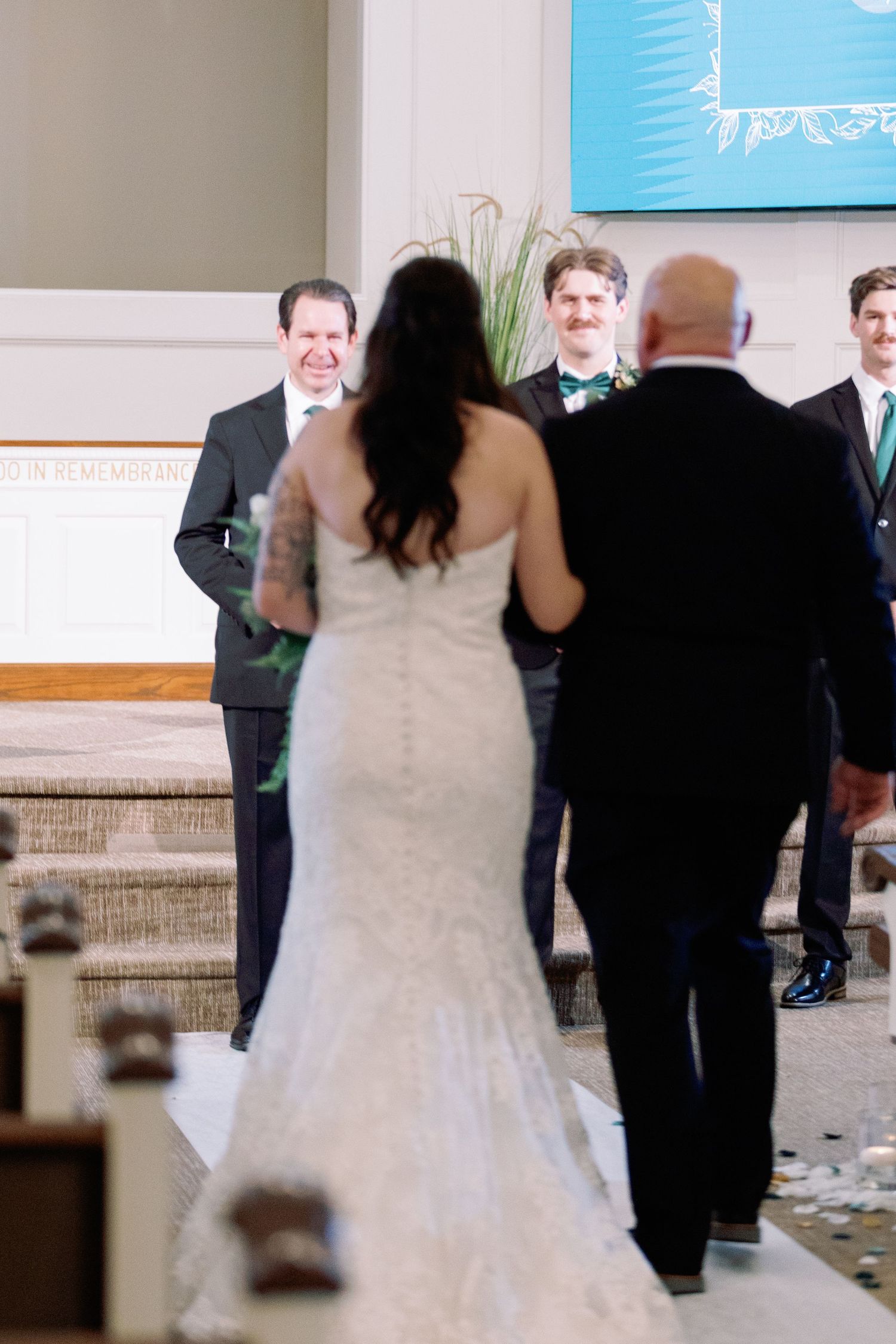 Wedding reception dance floor scene with guests in formal attire moving in a blur of motion.