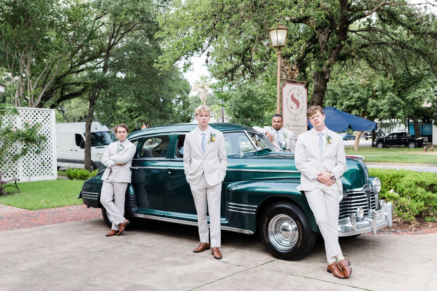 Classic green vintage car showcased at an outdoor event with retro styling.