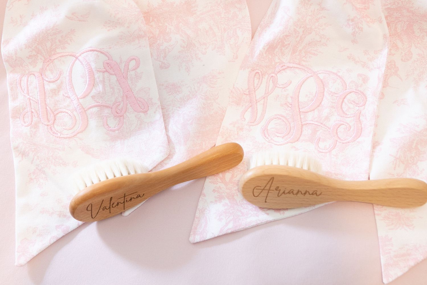 Two hands hold small slips of pink or salmon colored paper containing handwritten notes and text.
