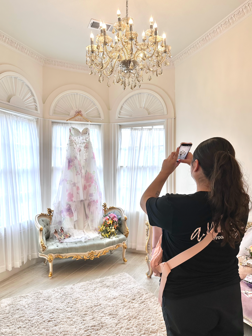 Elegant white room with crystal chandeliers and arched windows creating a romantic bridal setting.