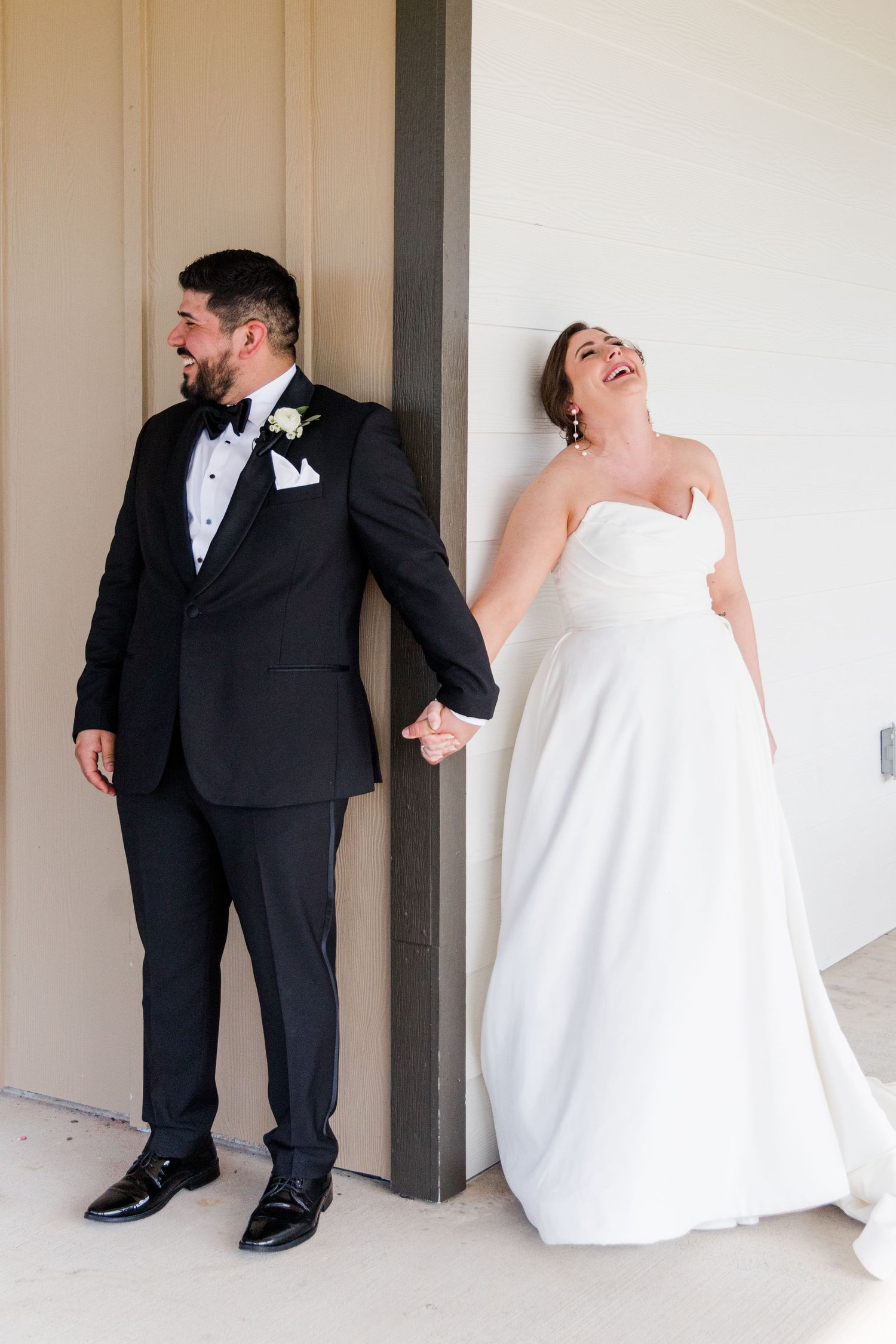 Wedding couple creates playful moments during their first look photo series.