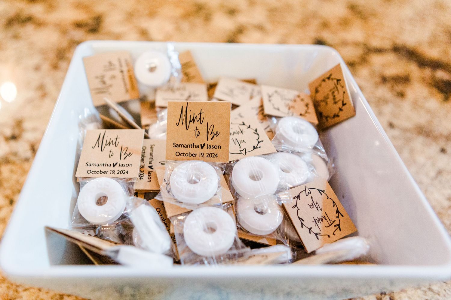 Wedding favors arranged neatly on a white serving tray.