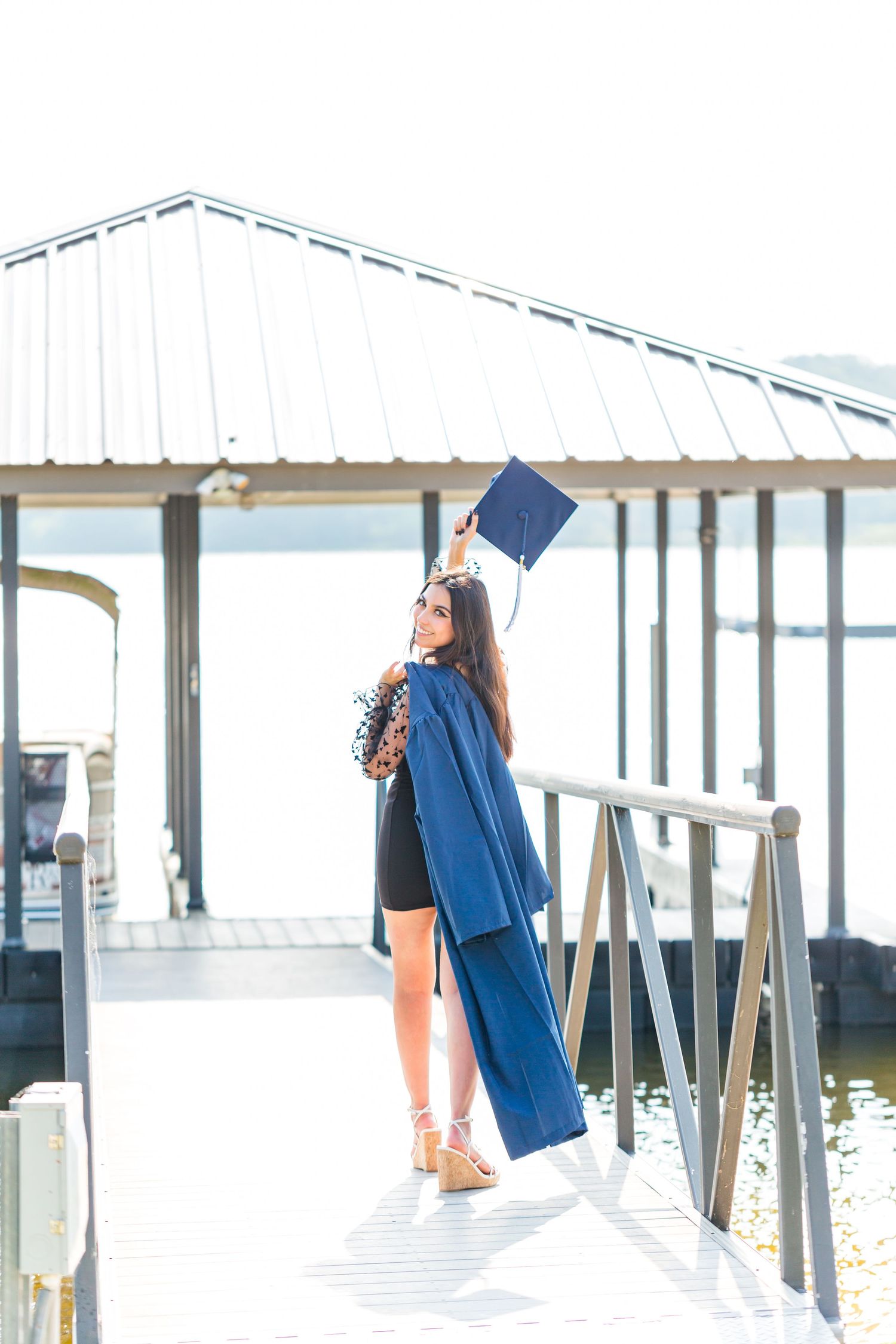 senior girl holding cap and gown