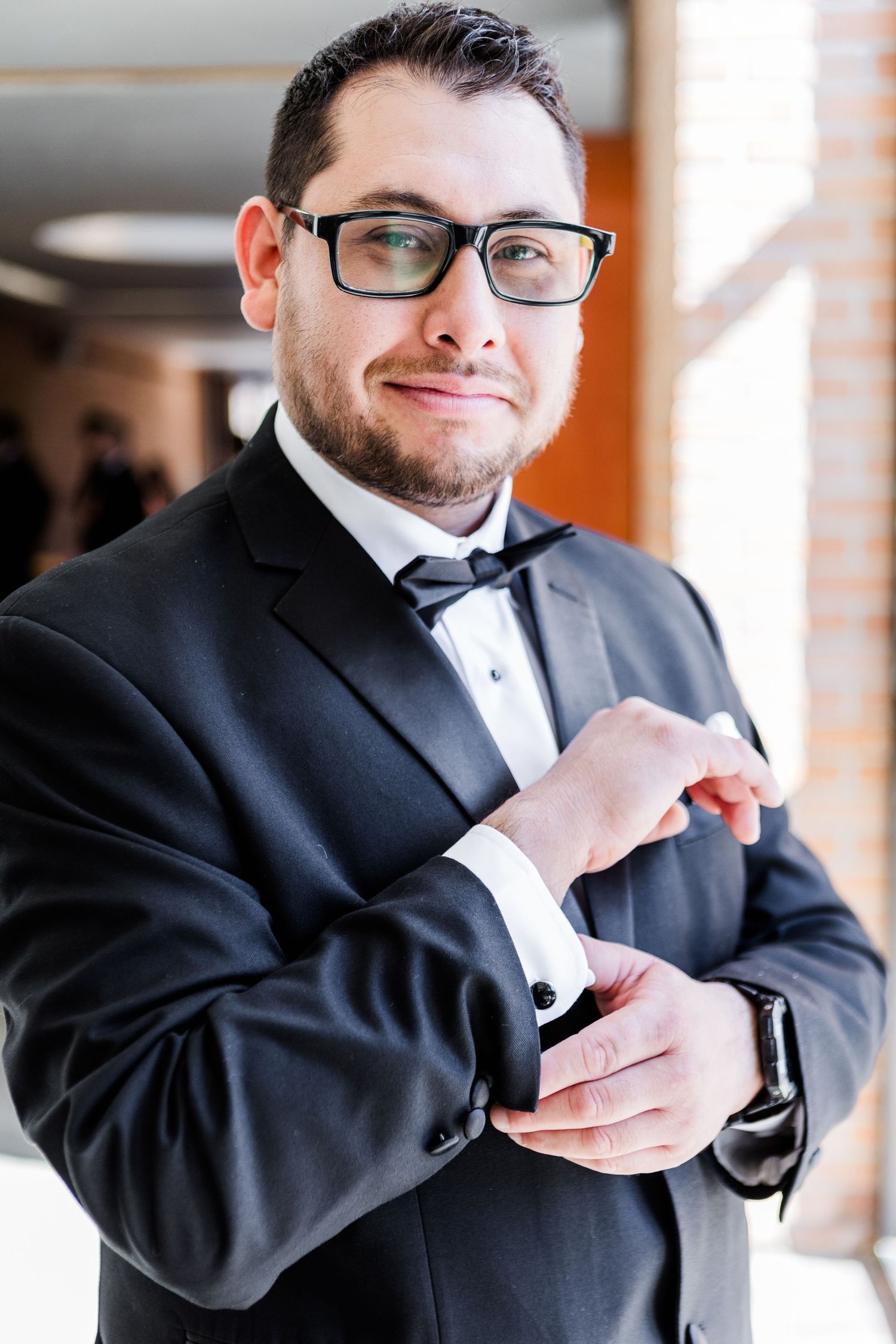 Close-up sequence of adjusting formal wear and accessories.
